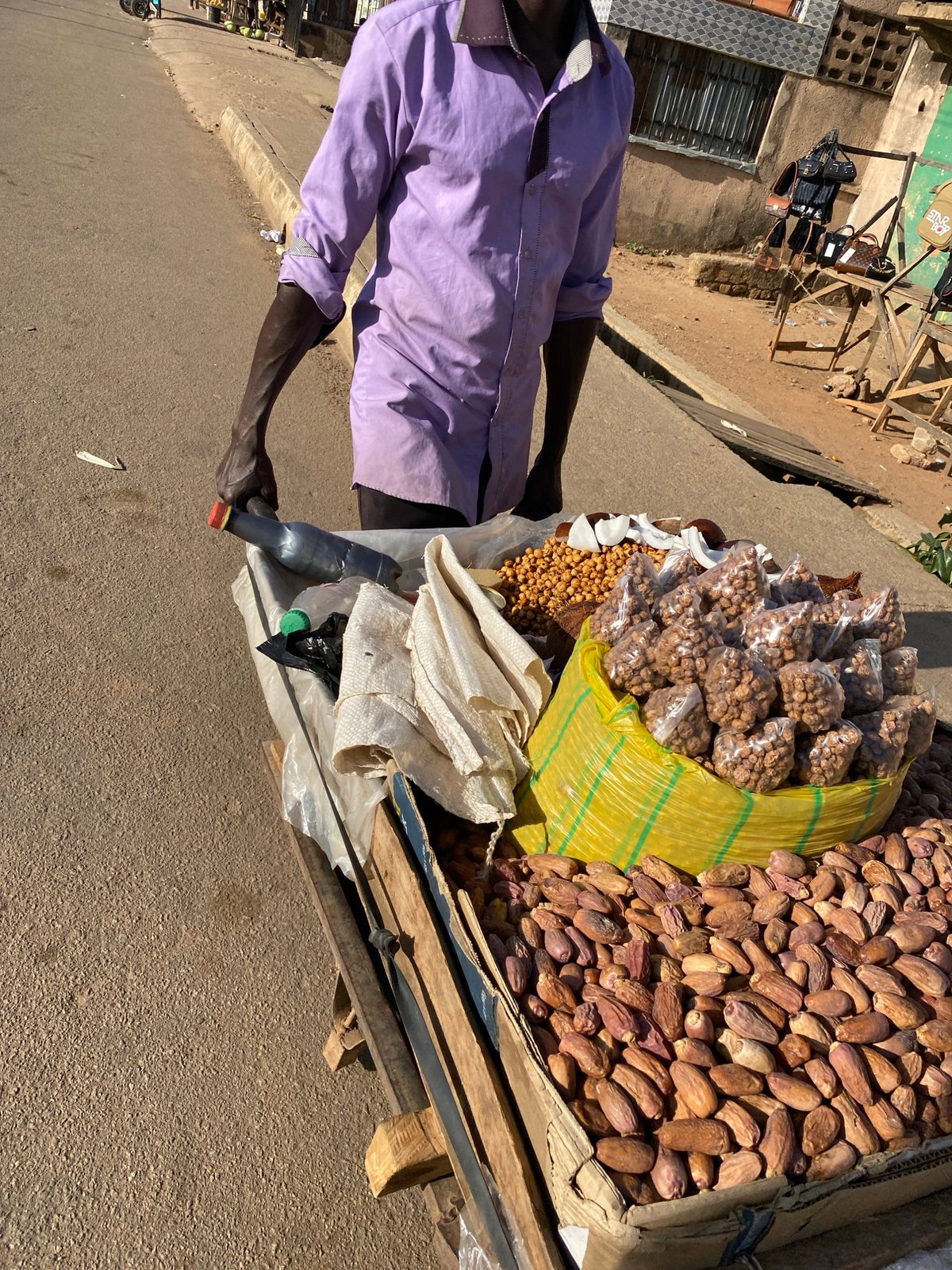 Street vendor sells goods from cart in Bukuru, Nigeria
