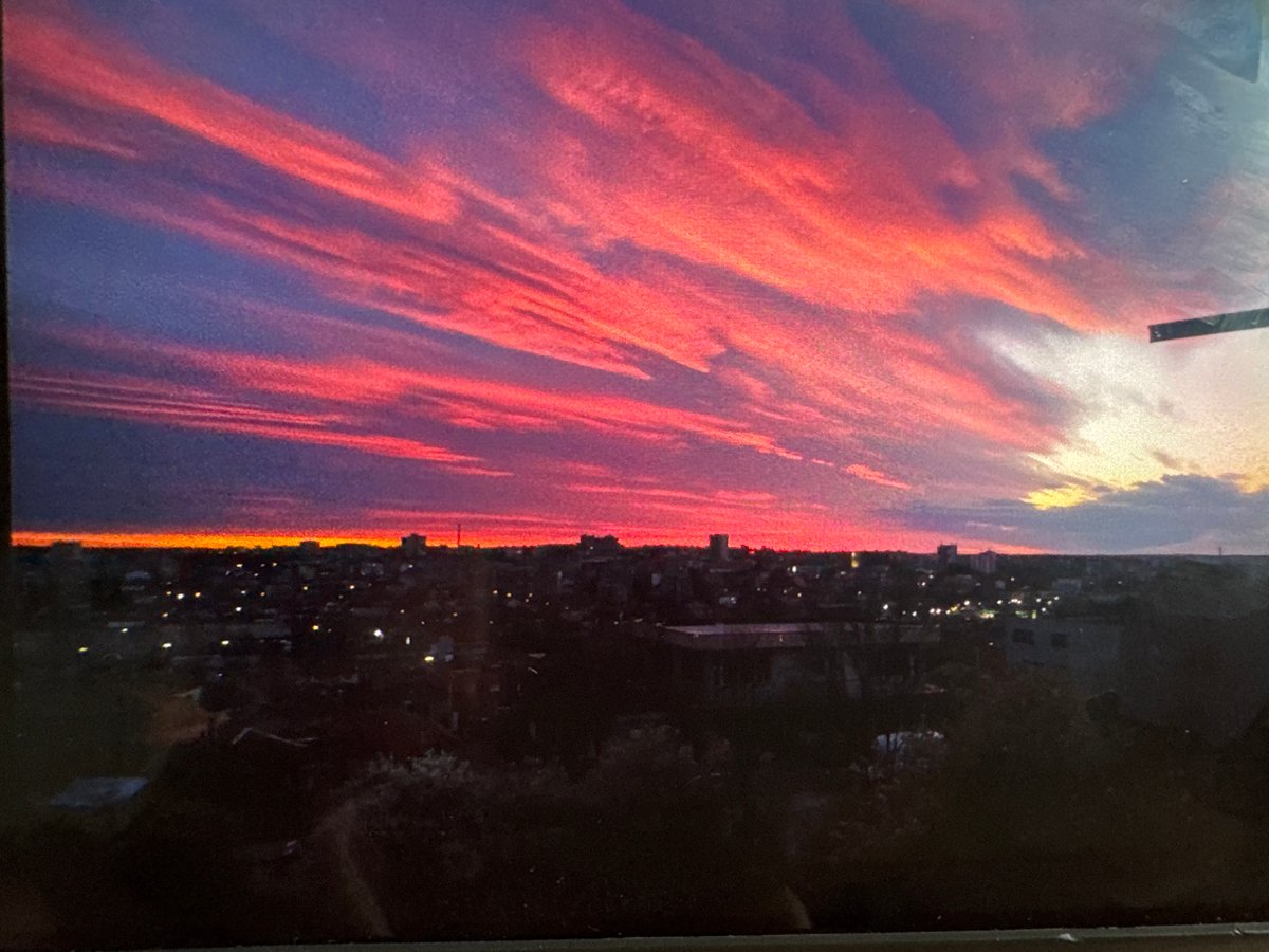 Colorful sunset illuminates Dobrich skyline with pink and purple clouds