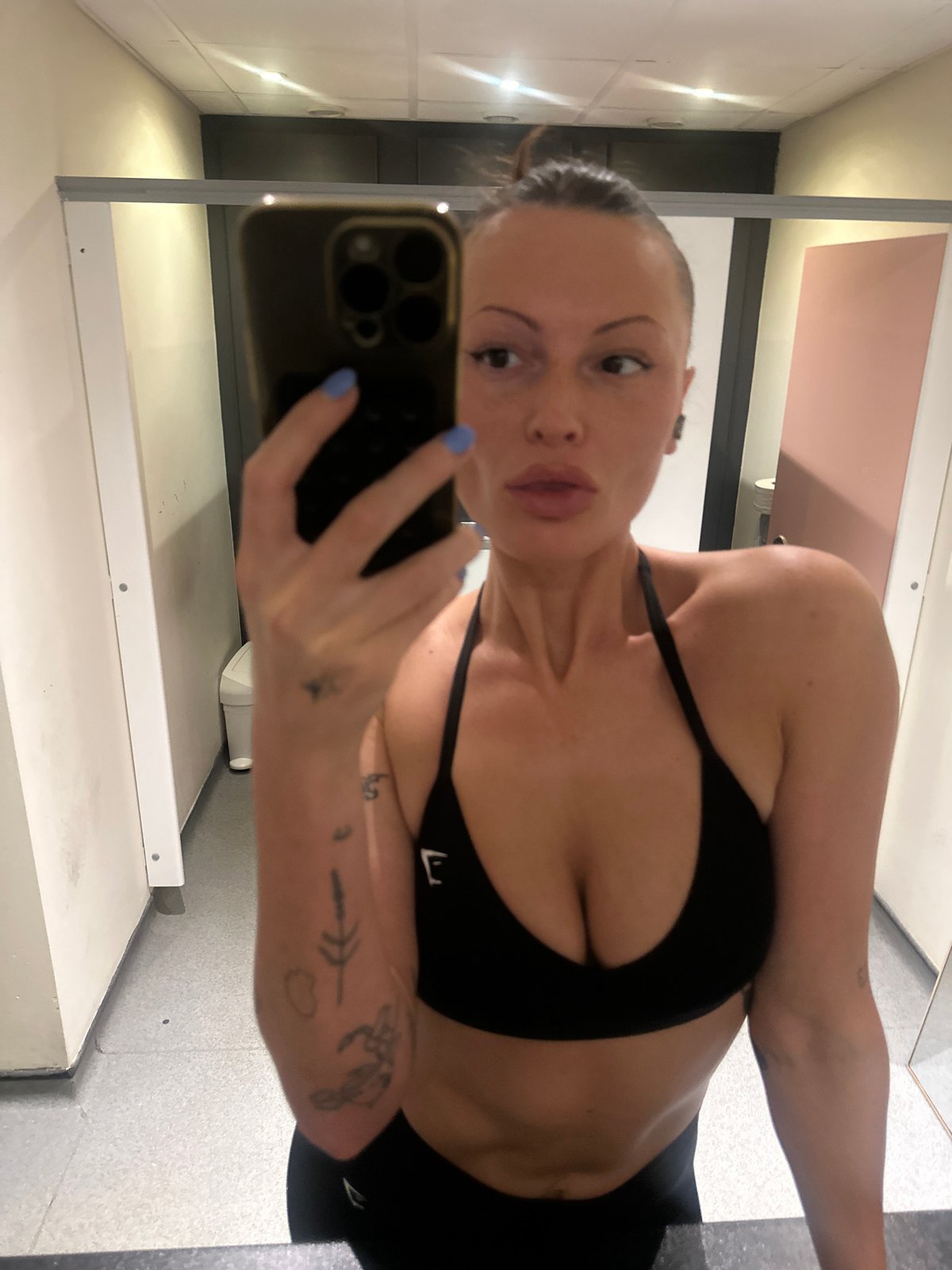 Woman takes mirror selfies in Tunbridge Wells public restroom