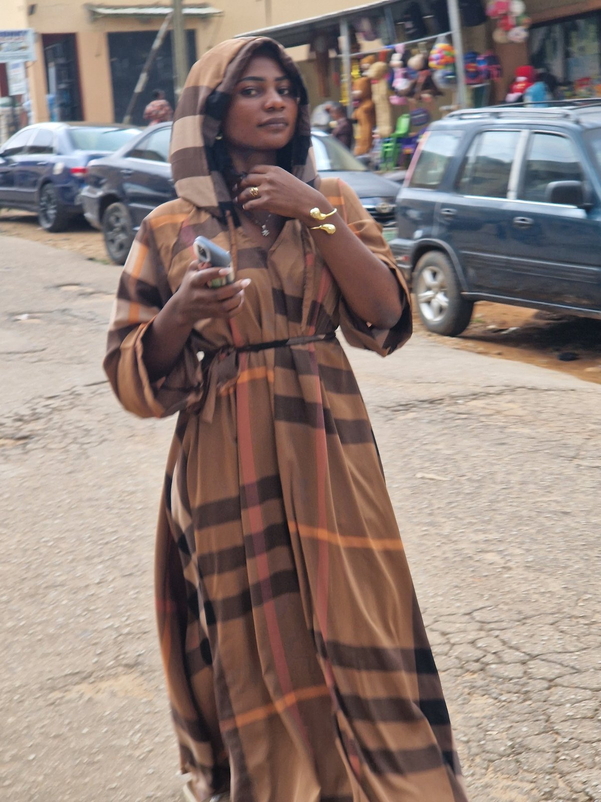 Street vendors and pedestrians moving through a busy urban market