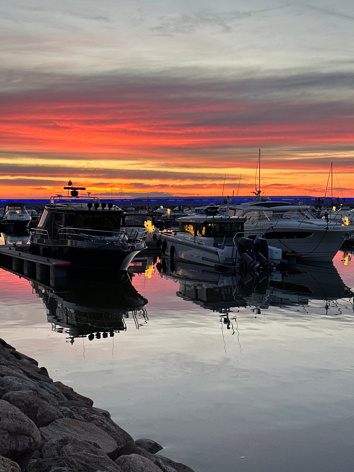 Tallinn marina at sunset, boats docked under a vivid sky