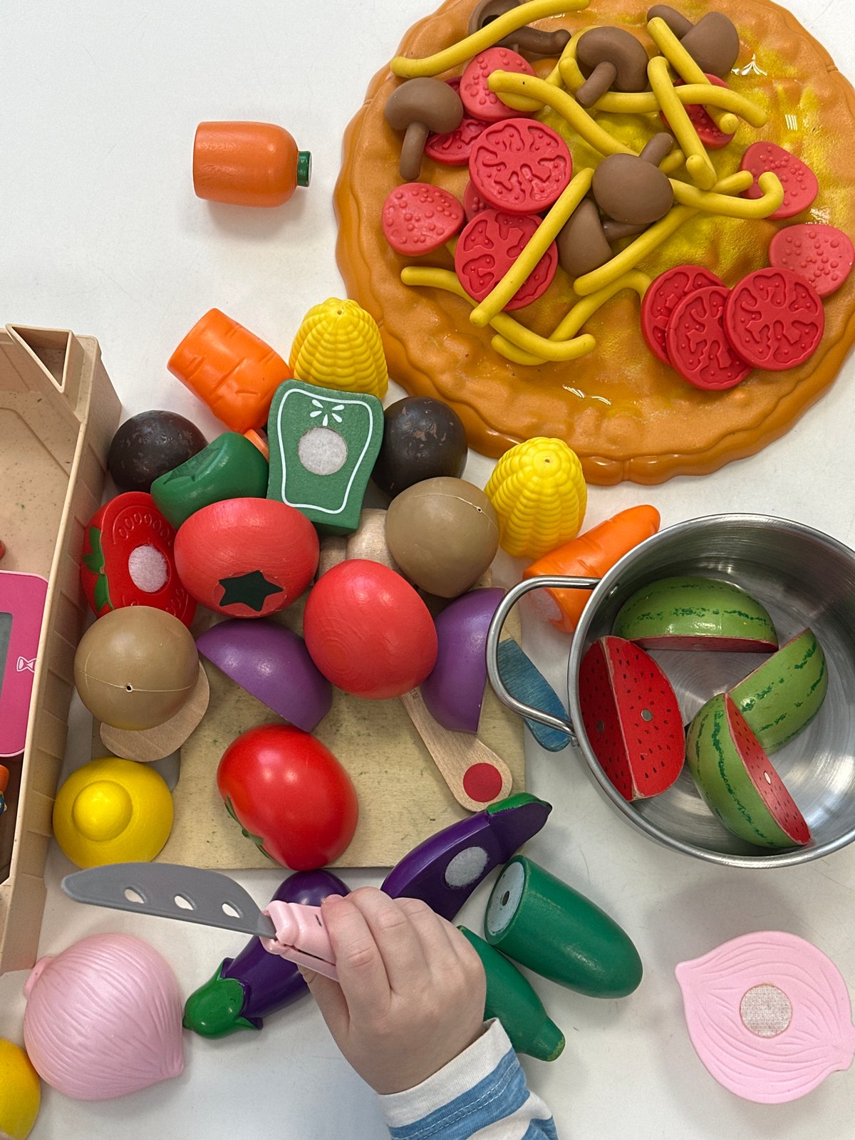 Child plays with toy food collection in Votkinsk