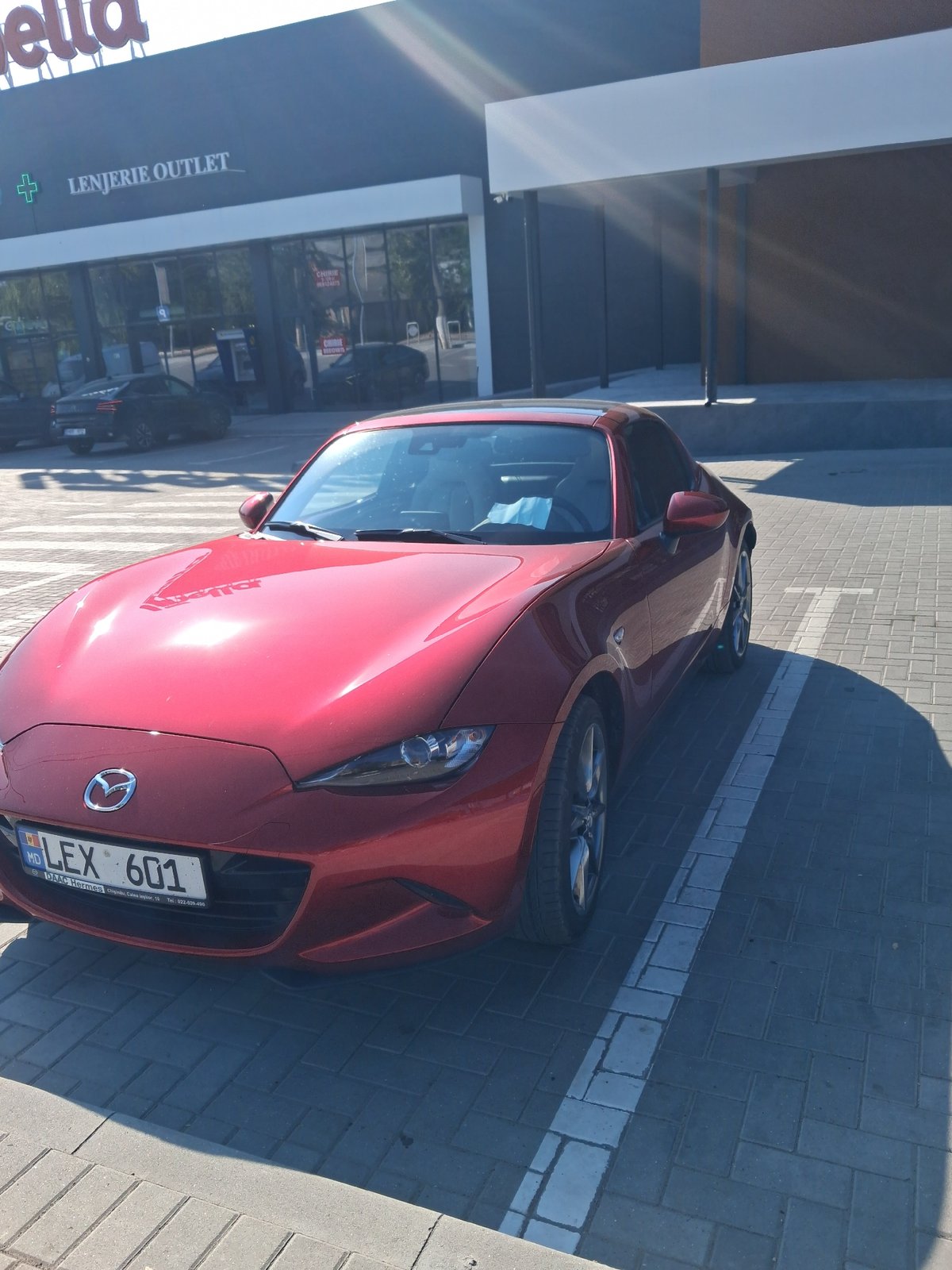 Red Mazda MX-5 parked in disabled spot outside Bălți outlet