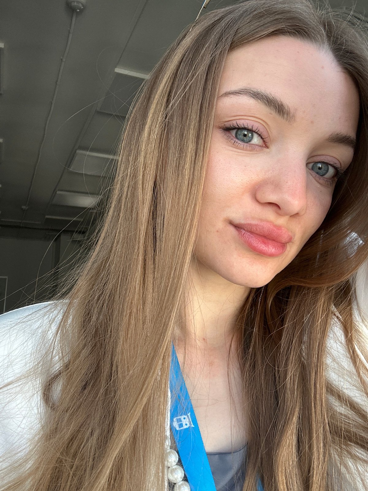 Woman photographed wearing lanyard in early morning Kazan selfie