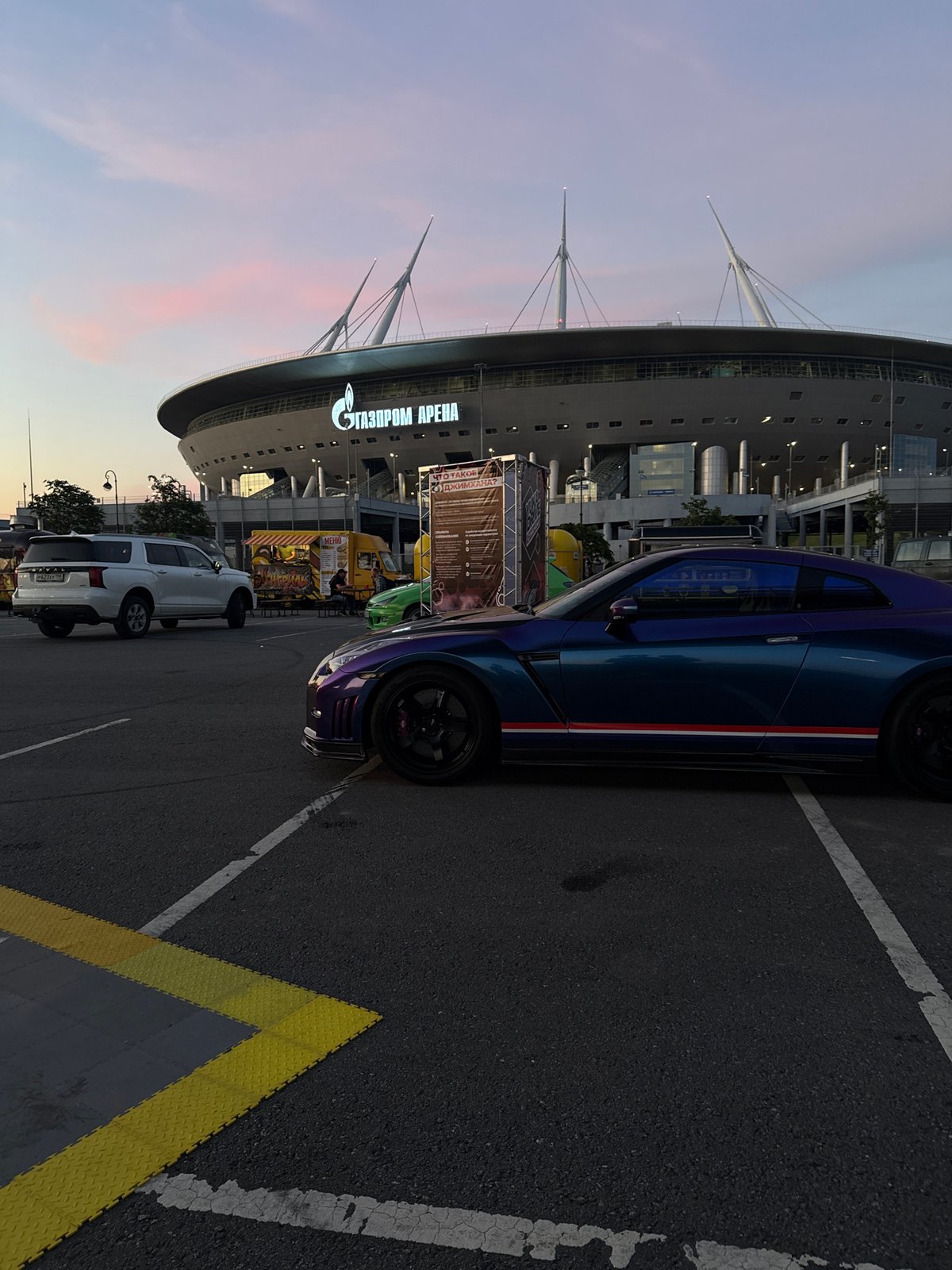 Gazprom Arena's curved exterior on a summer evening in St. Petersburg