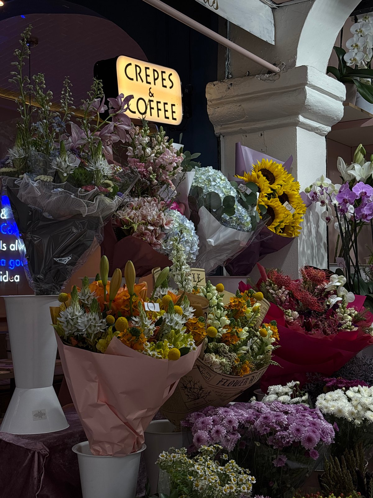 Evening observations capture flower shop display and pedestrian
