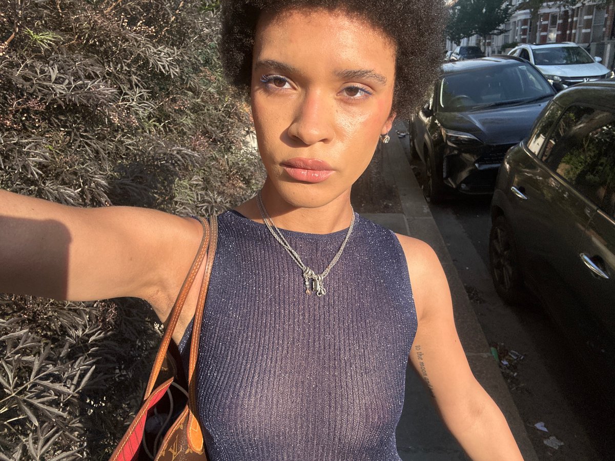 Portrait in sparkly blue top with matching eyeliner, London