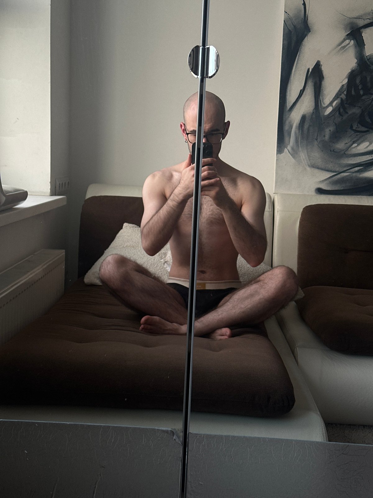 Man photographs himself on couch in Moscow apartment