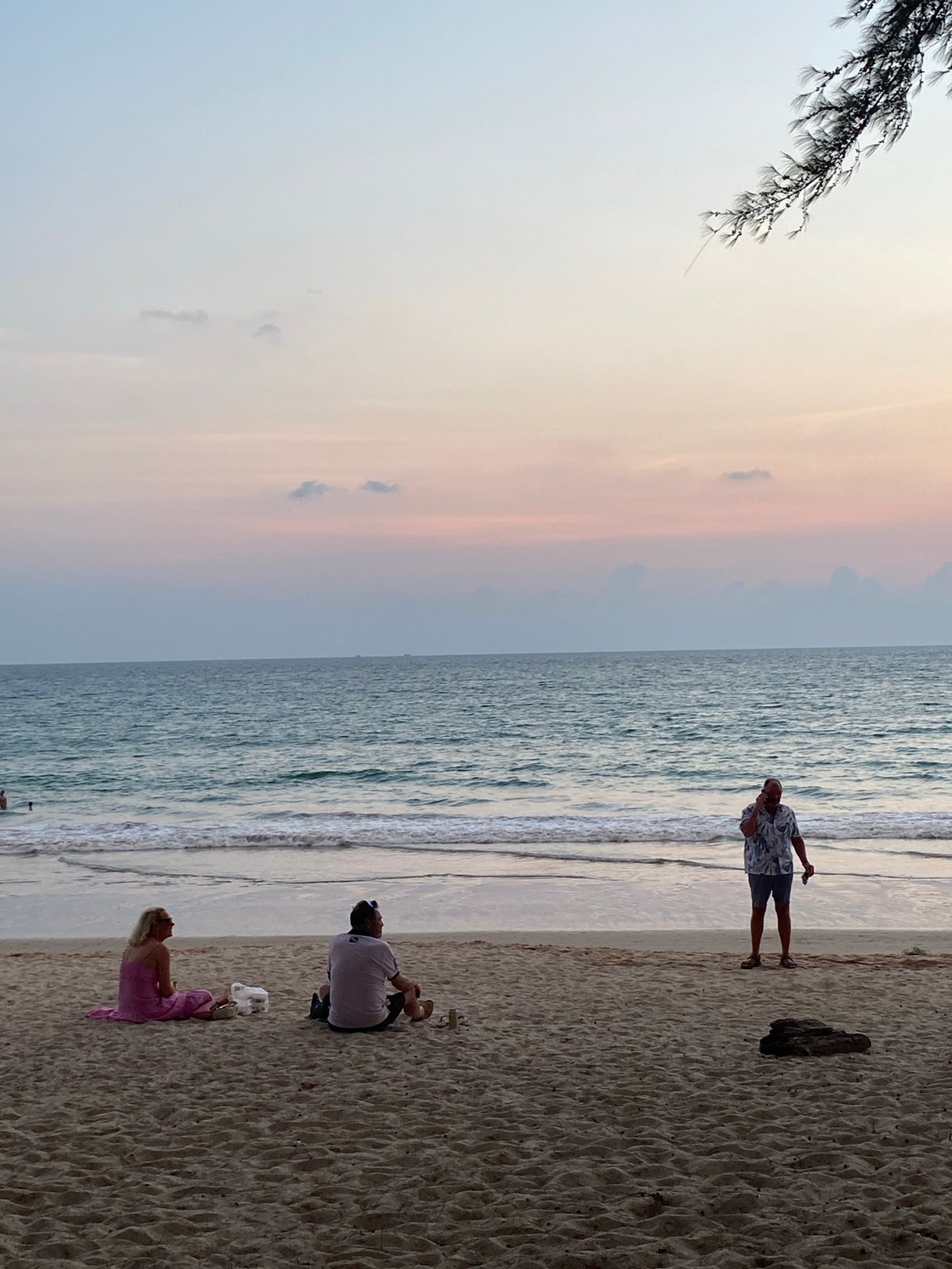 Sunset beach gathering captured in Choeng Thale, Thailand