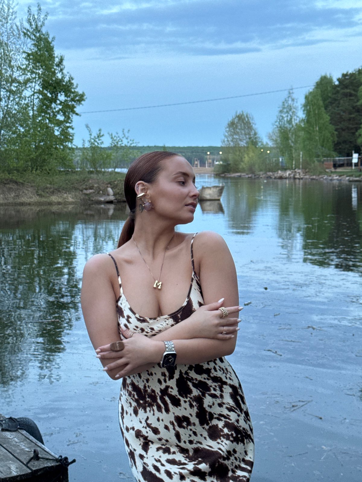 Waterfront moments captured in Chaikovsky: woman poses, child watches duck