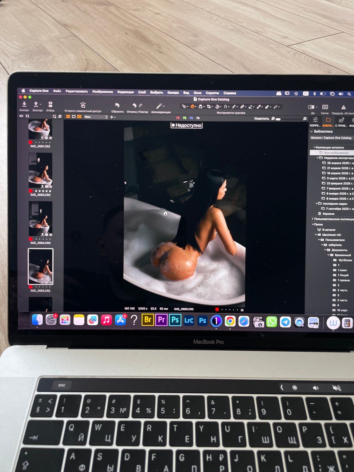 Photographer edits portrait sessions on laptop in Kazan