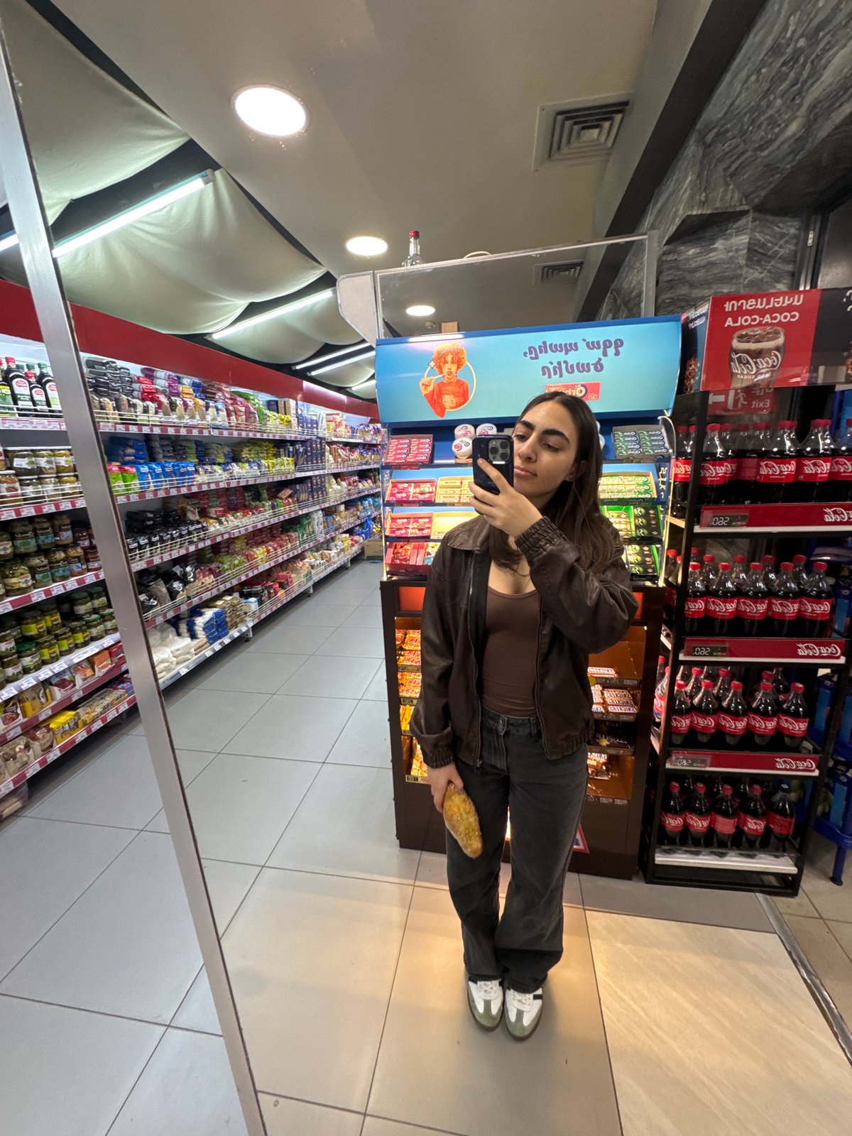 Woman takes mirror selfie in Yerevan supermarket