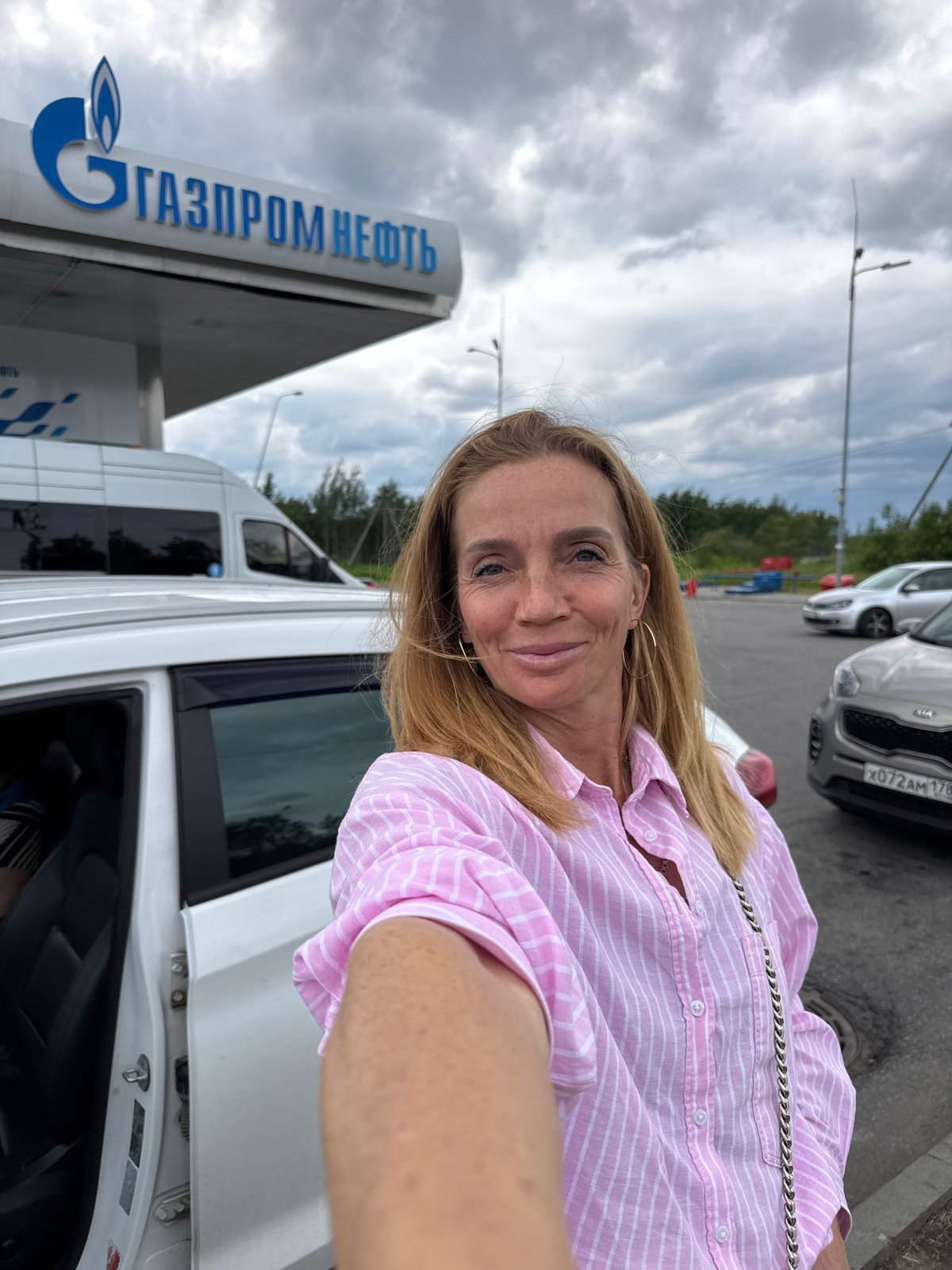 Woman takes selfies at Russian gas station