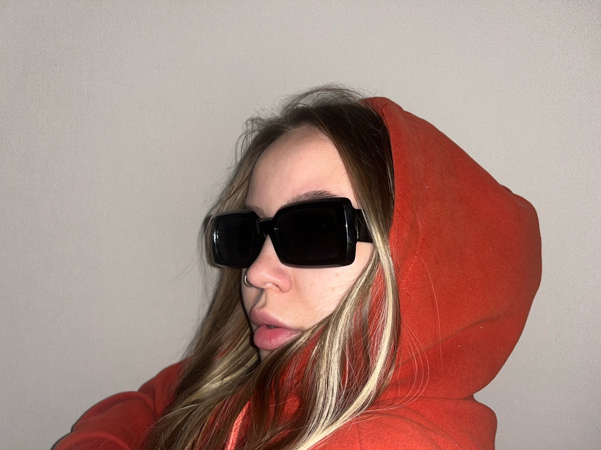Person in orange hoodie photographed upside-down in Krasnodar