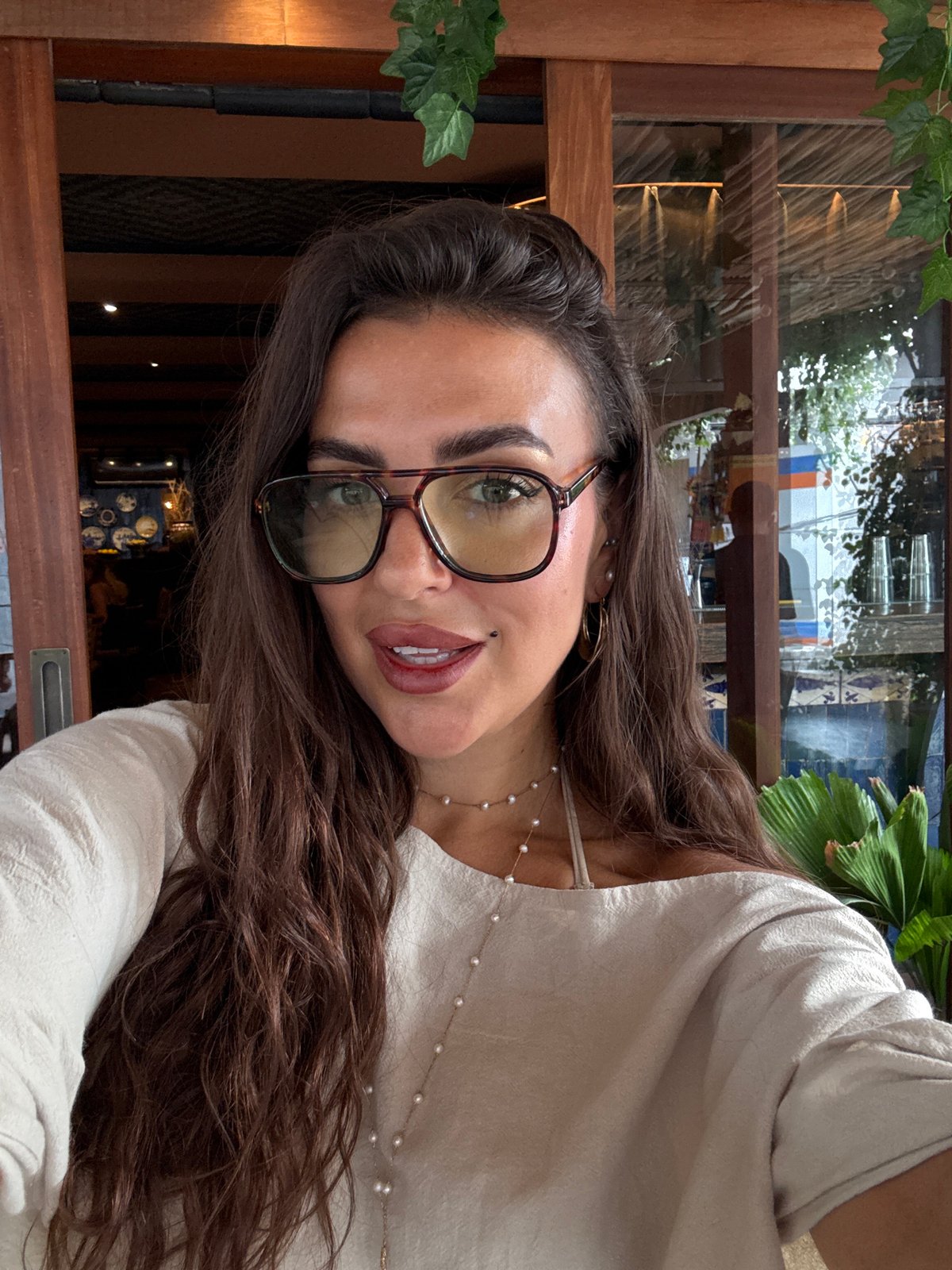 Woman takes selfies indoors in Kuta Selatan, Indonesia