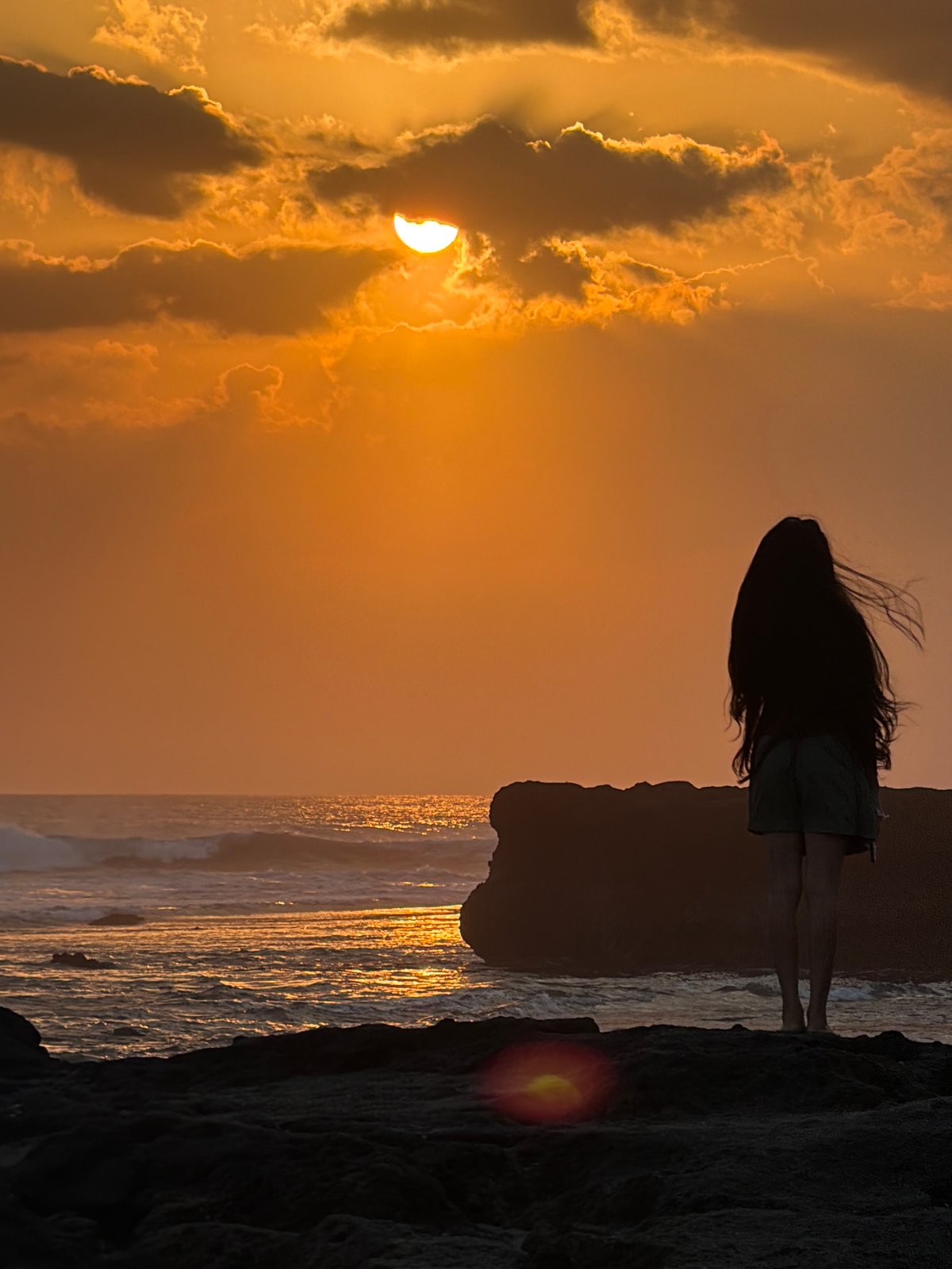 Sunset on the rocks at North Kuta's shoreline