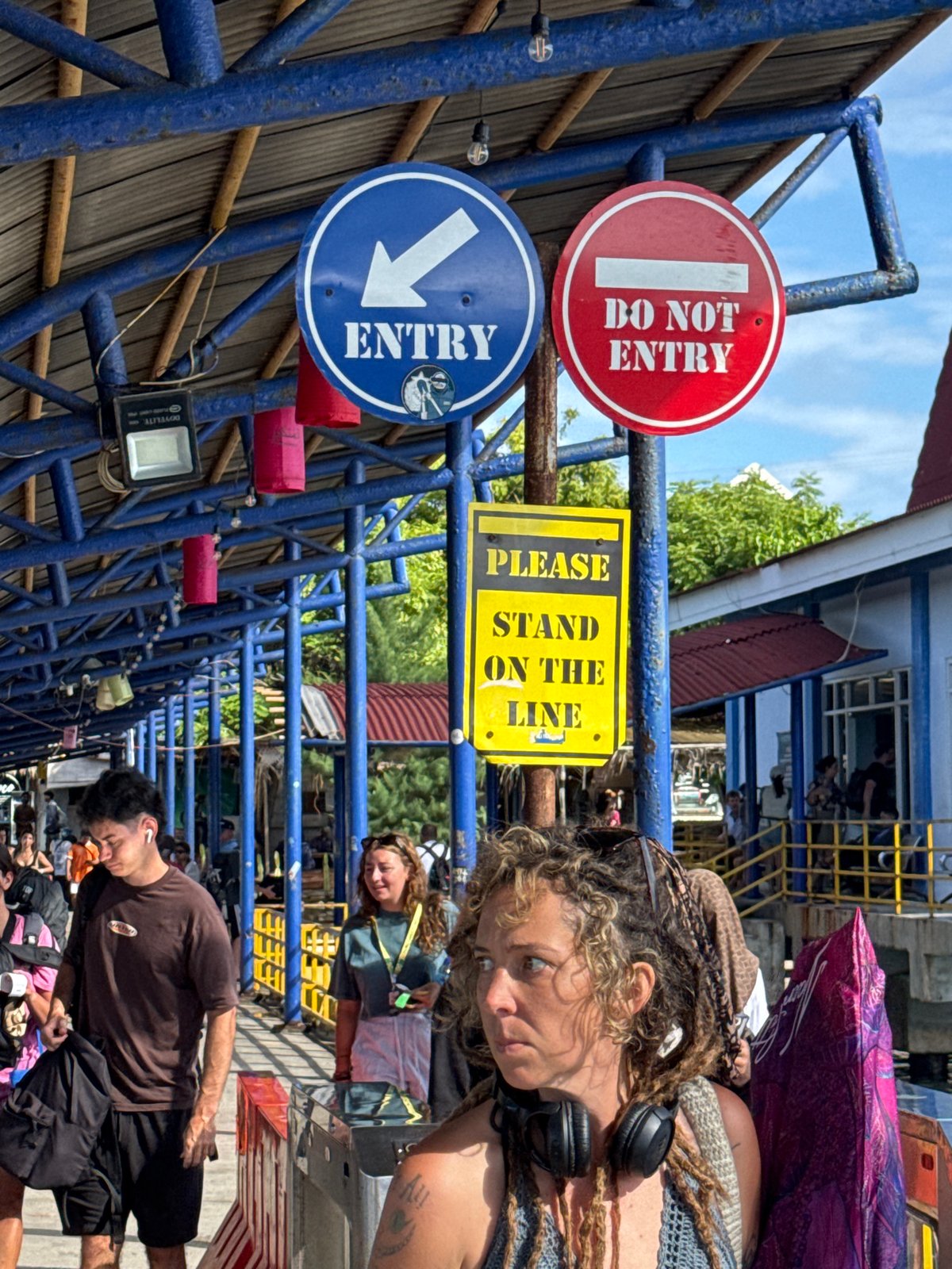 Outdoor queuing area with blue barriers observed in Indonesia