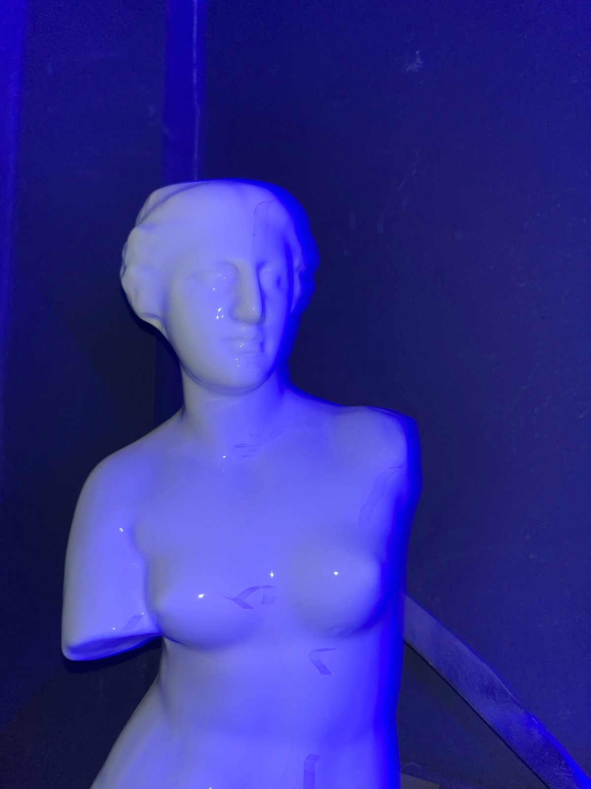 White mannequin displayed in blue-lit Accra bar early Monday