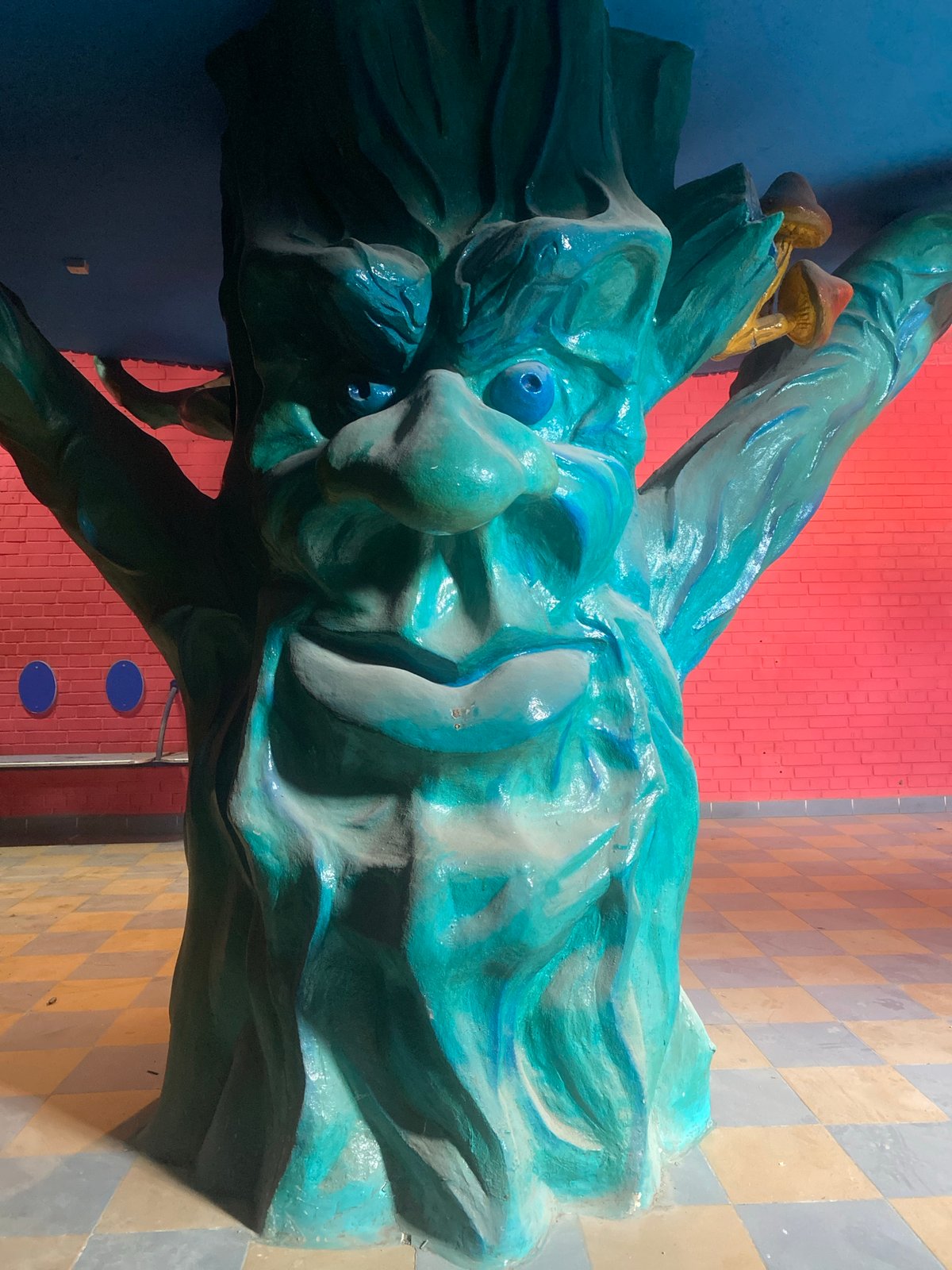 Fantastical sculptures including dragon and robot displayed indoors