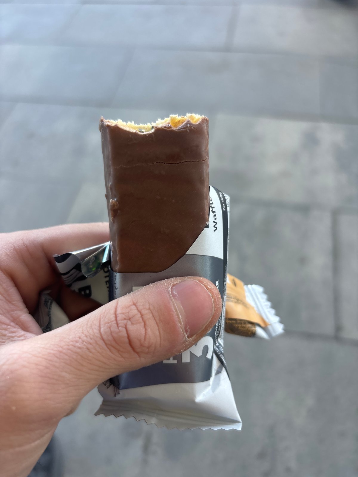 Person enjoys chocolate wafer bar in Plovdiv, Bulgaria