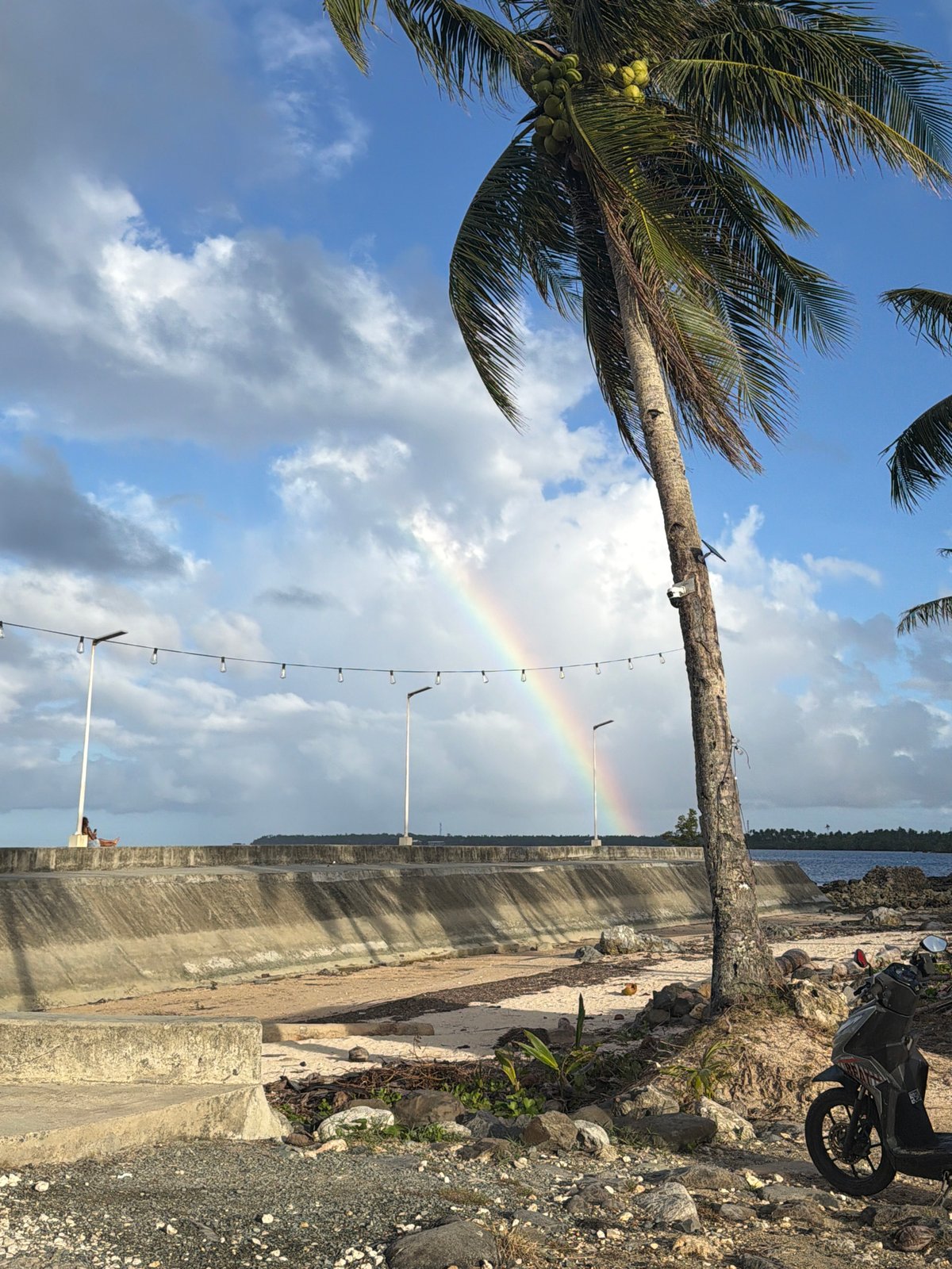 Rainbow appears over General Luna coastline amid cloudy skies