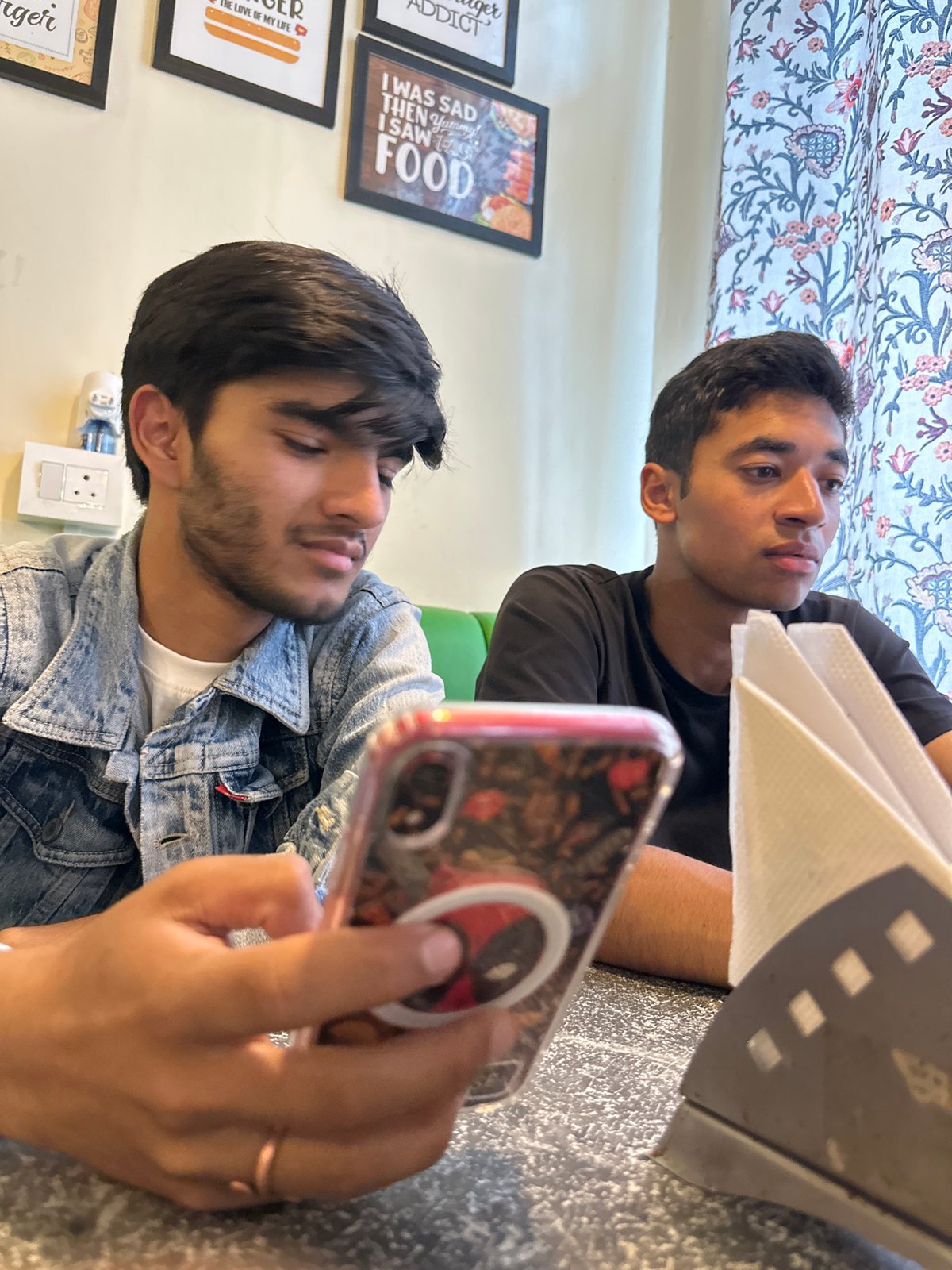 Hanging out at a cafe, phones in hand