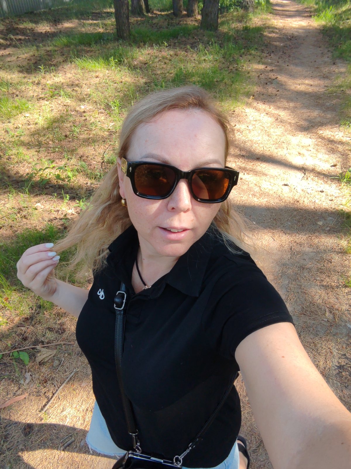 Woman Takes Morning Selfie on Forest Path in Russia