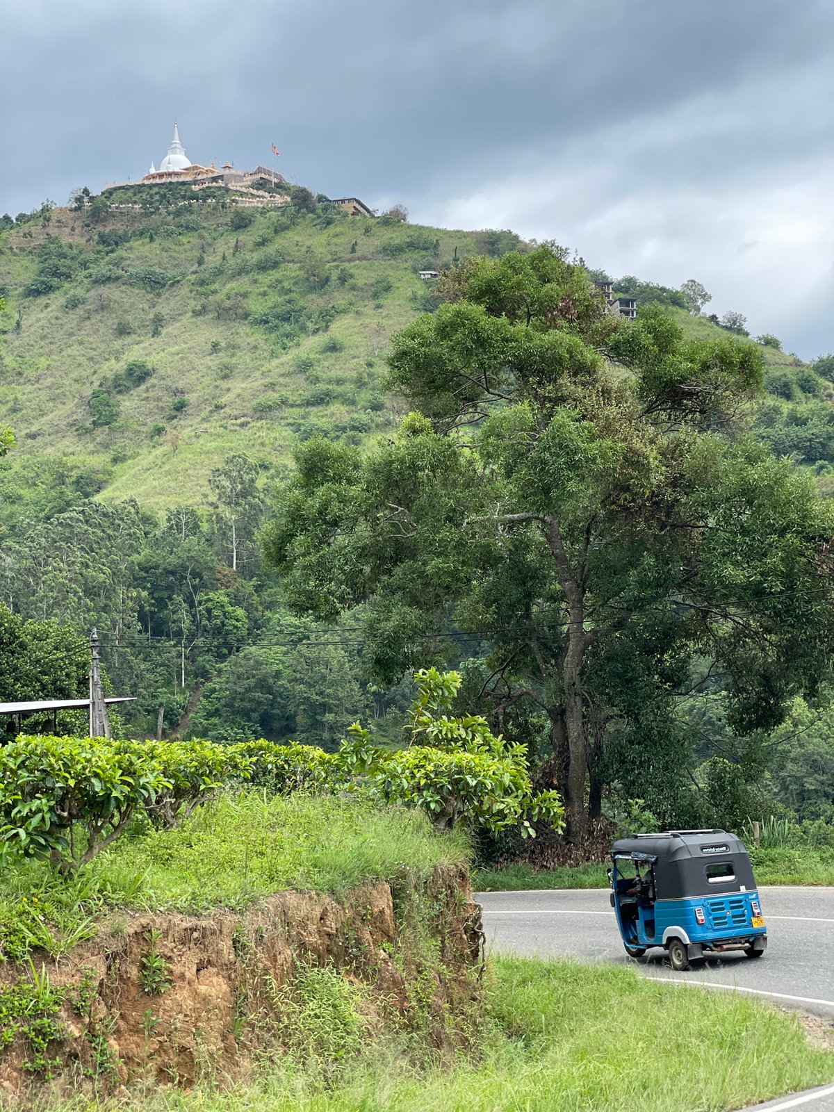 Morning traffic documented near Buddhist stupa in Kumbalwela, Sri Lanka