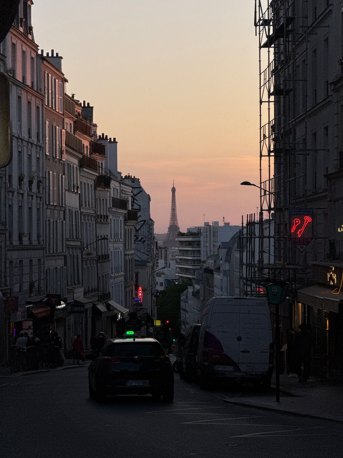 Golden hour illuminates Parisian street with Eiffel Tower view