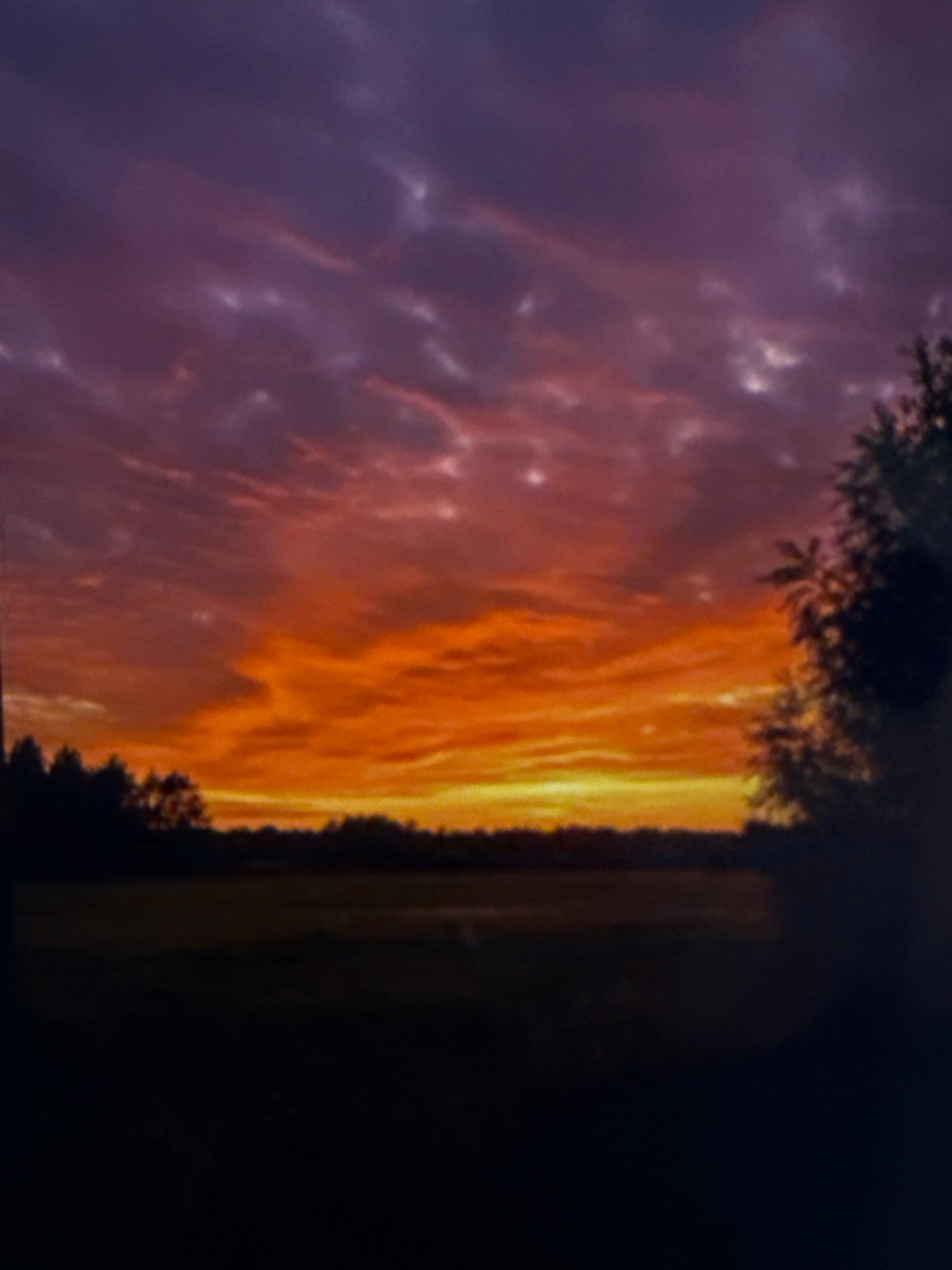 Digital display shows vibrant sunset imagery at unknown location