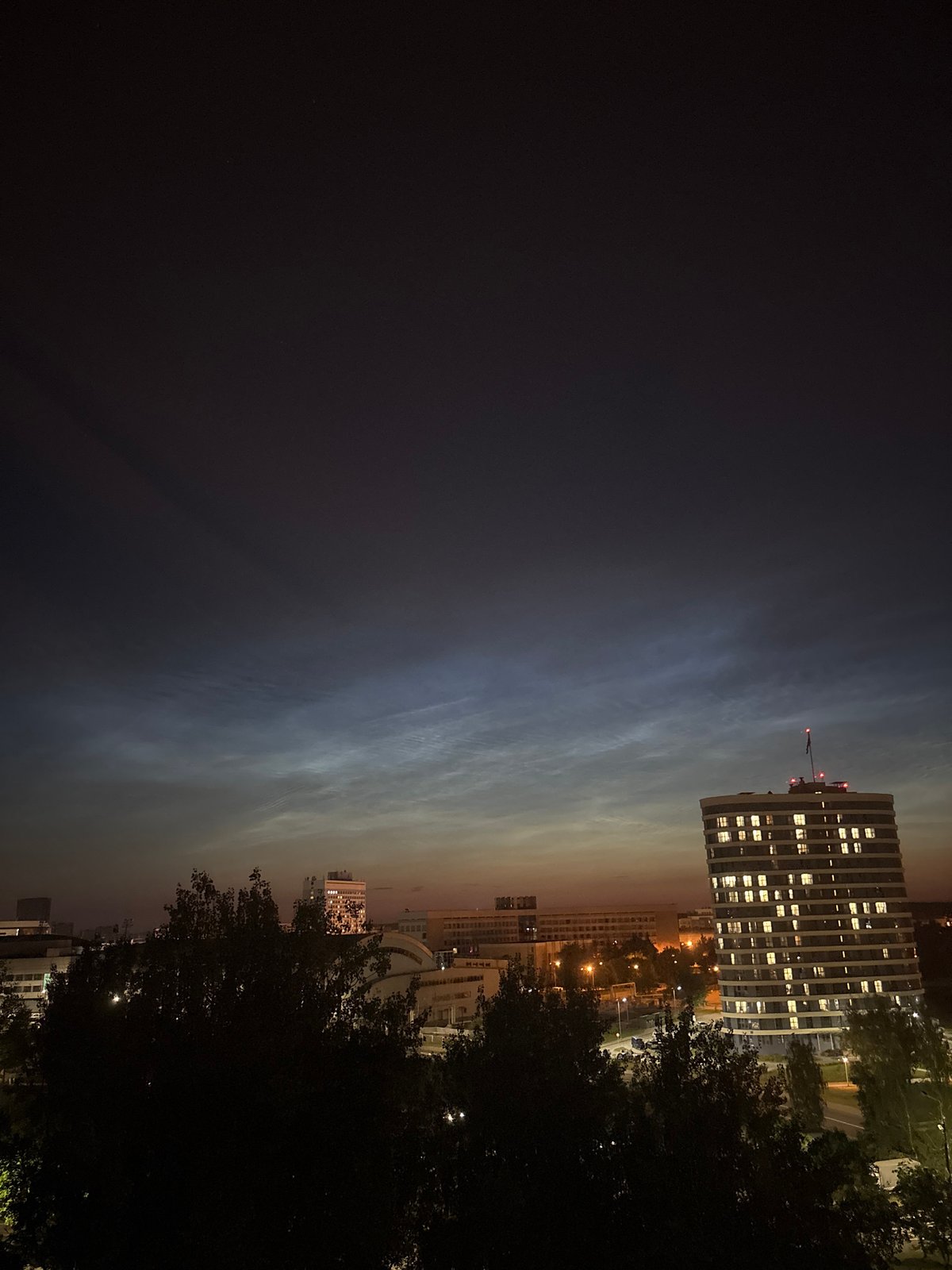 Dusk clouds and city lights from an elevated urban lookout