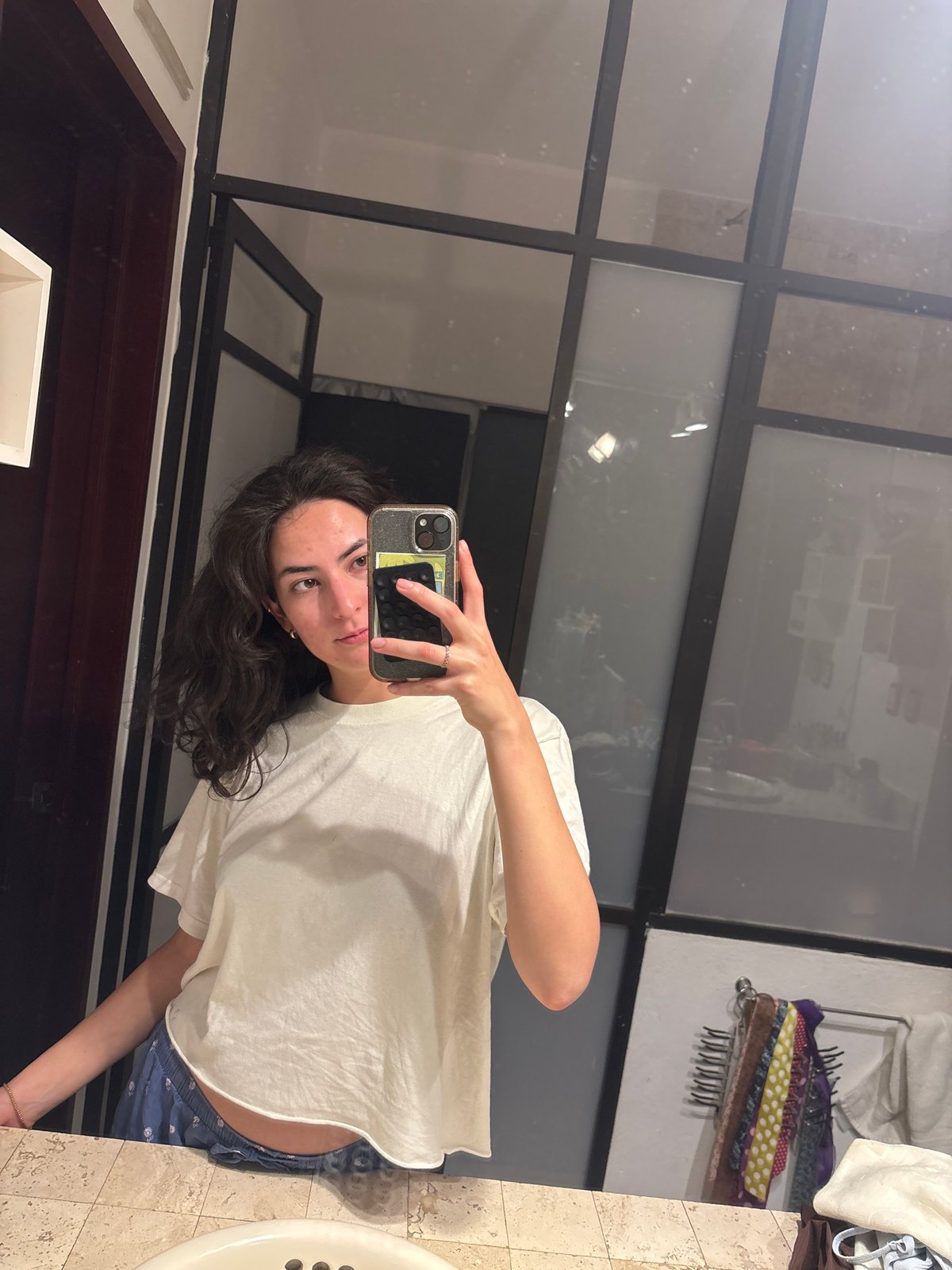 Person takes bathroom mirror selfies in Puebla, Mexico