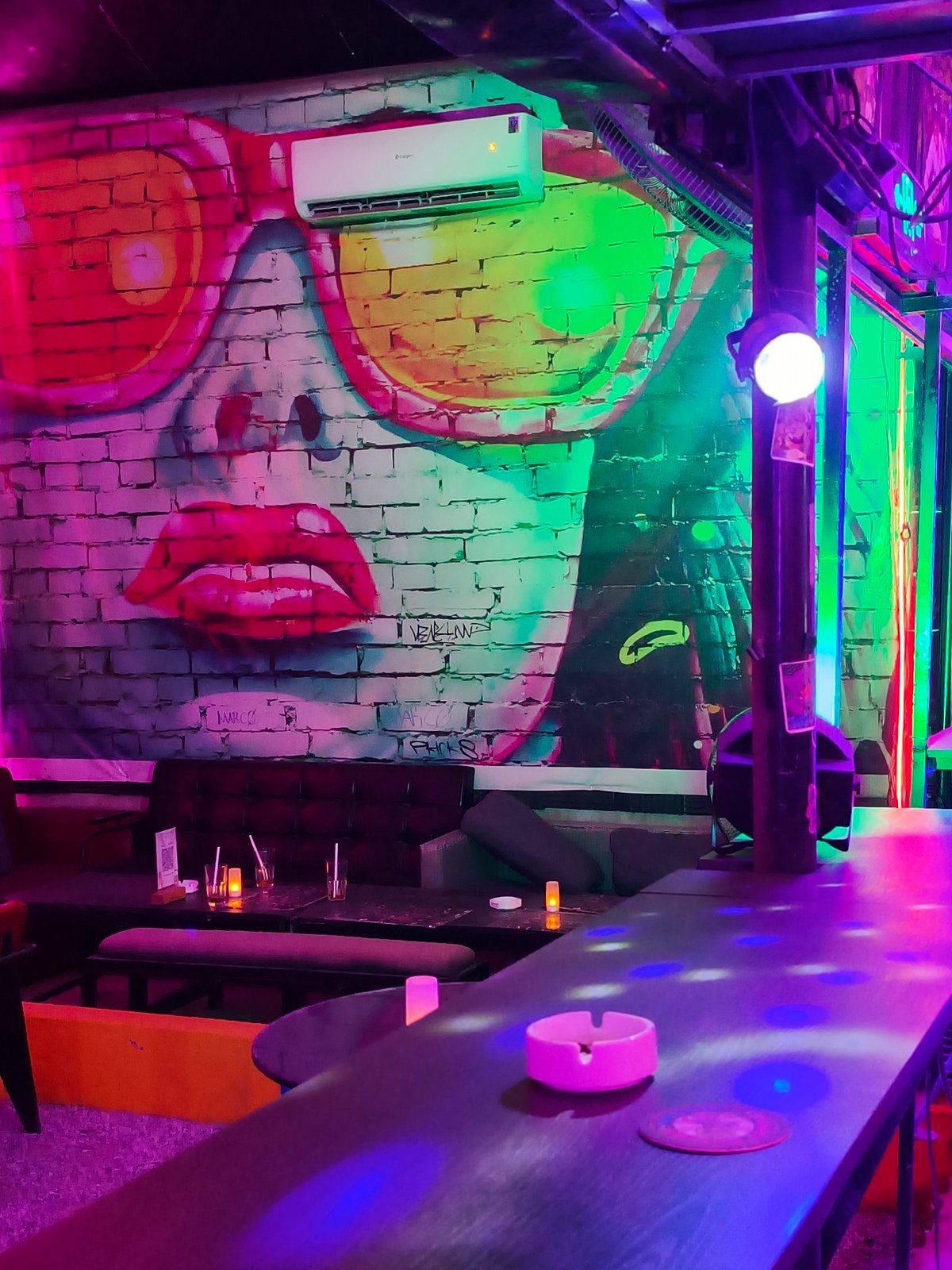 Inside a neon-lit bar in Đà Nẵng on a July night