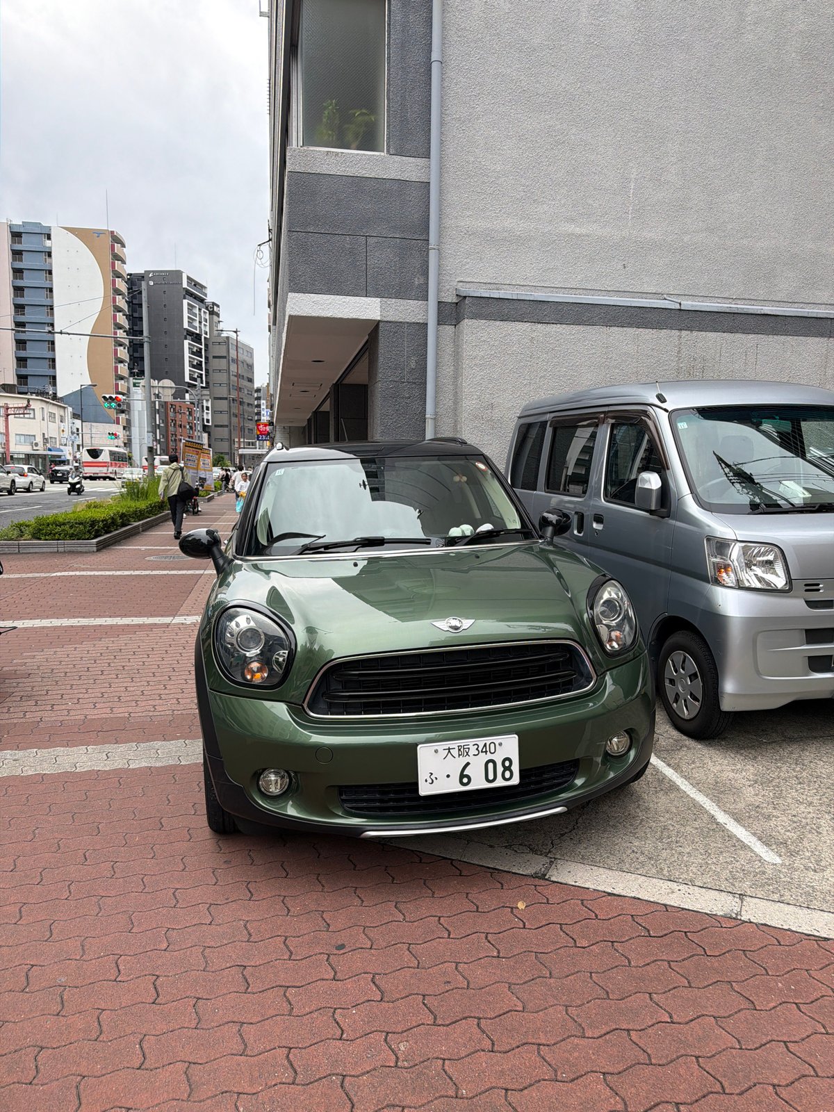 Morning street life documented across central Osaka under overcast skies