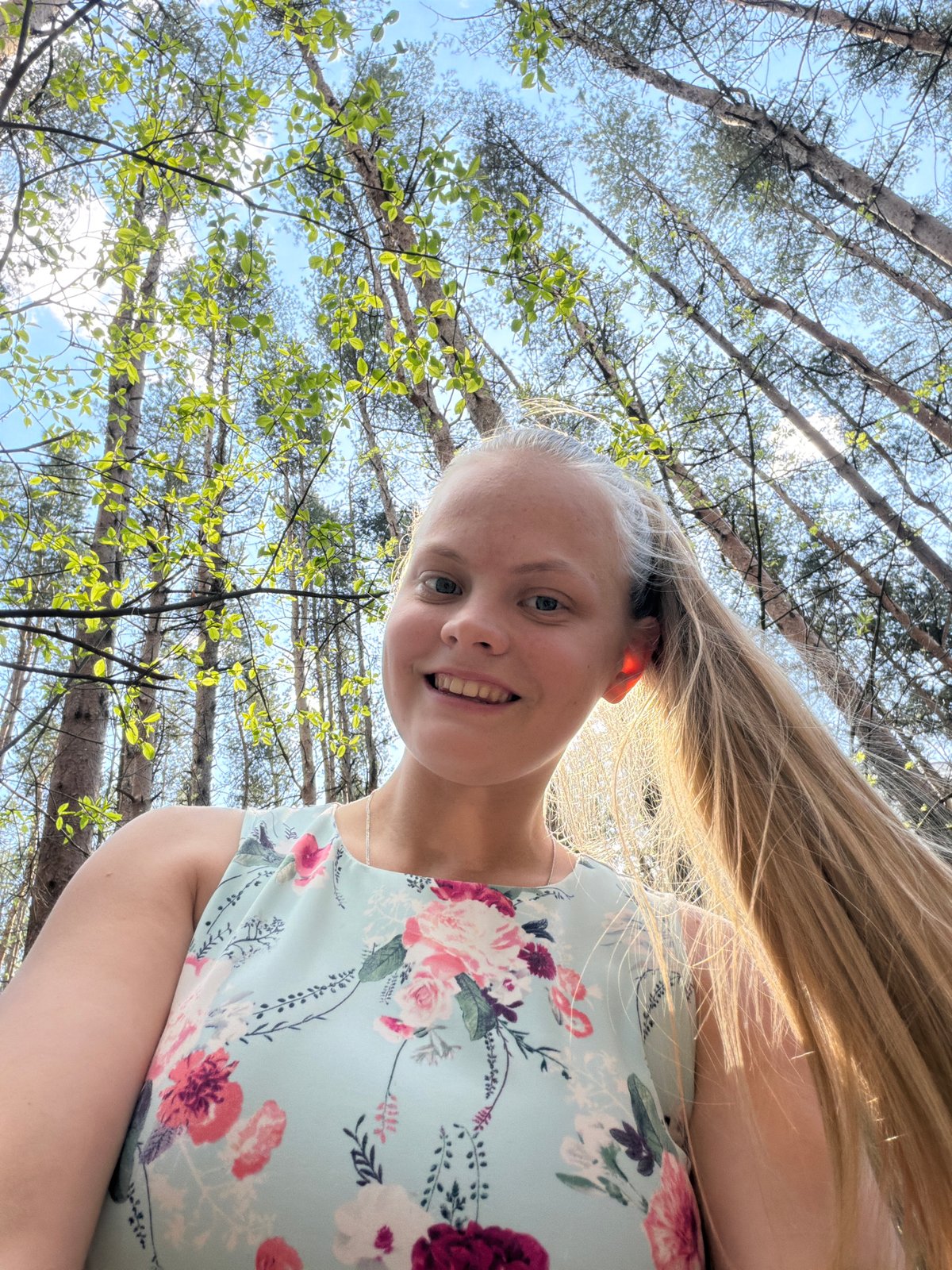 Woman in floral dress photographed walking forest path in Izhevsk