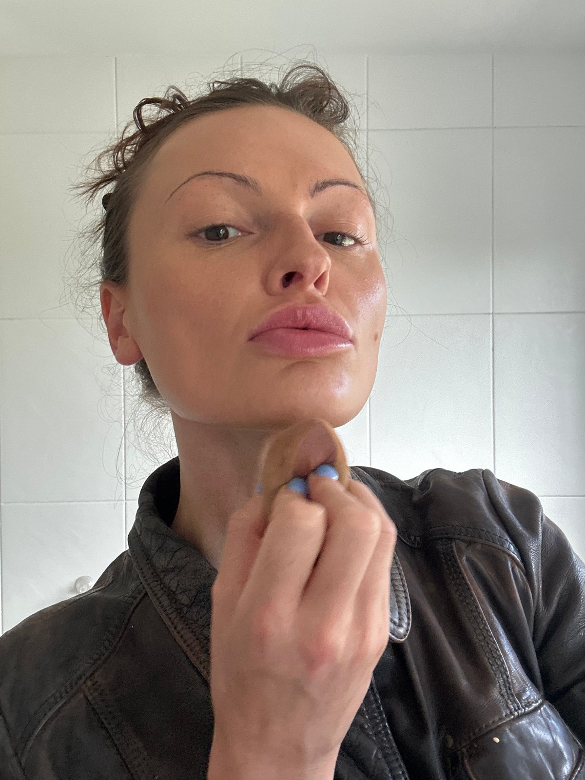 Woman applies makeup in Tunbridge Wells bathroom
