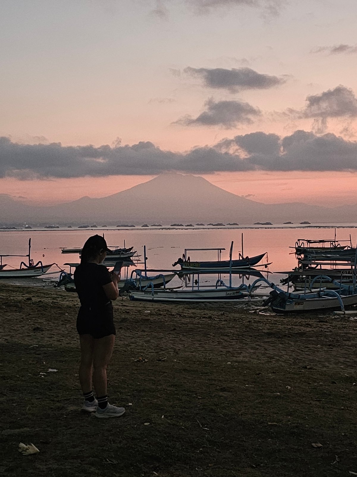 Twilight at the Denpasar coast with Mount Agung on the horizon