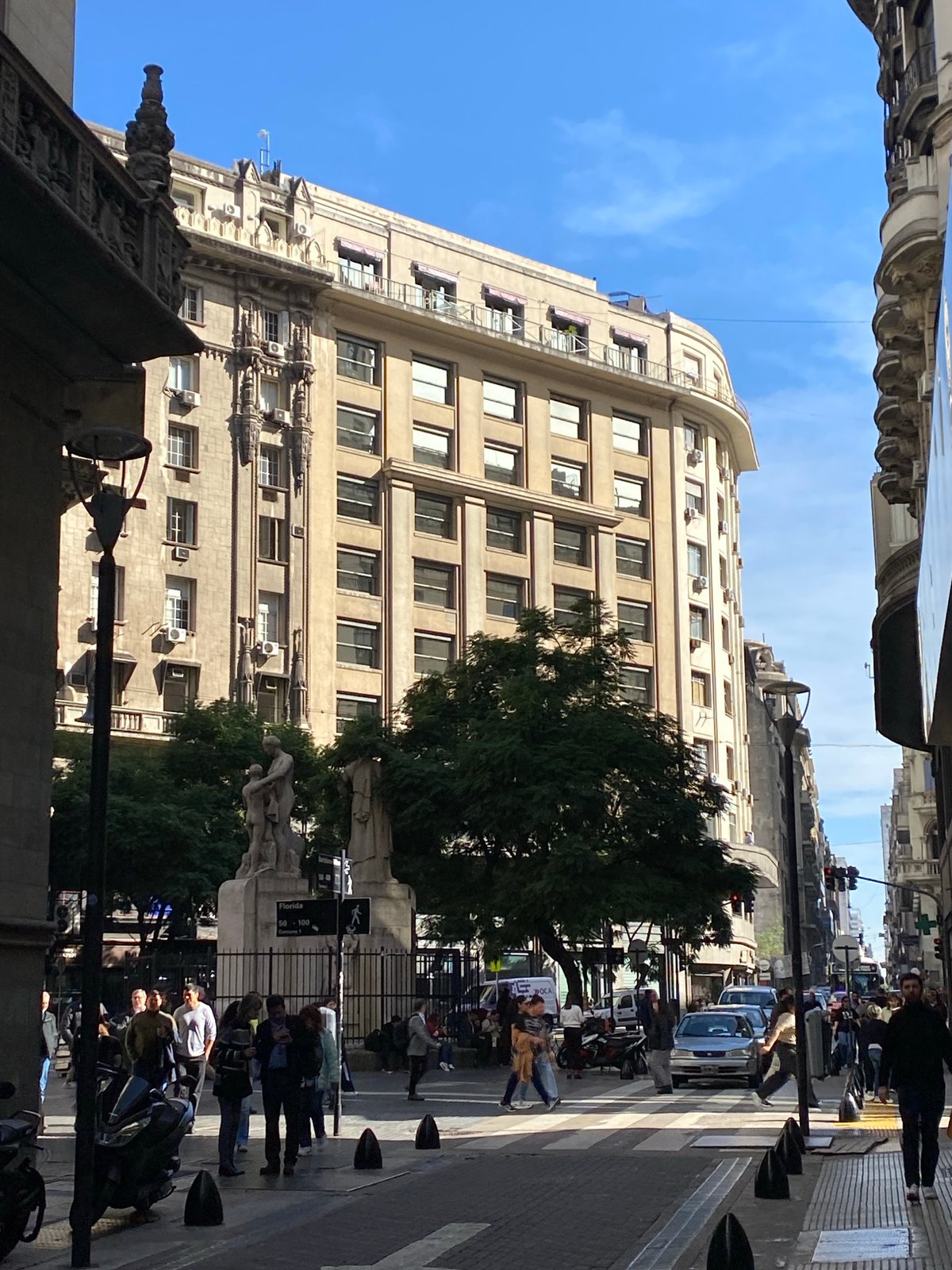 Woman cycles across Buenos Aires crosswalk on folding bike