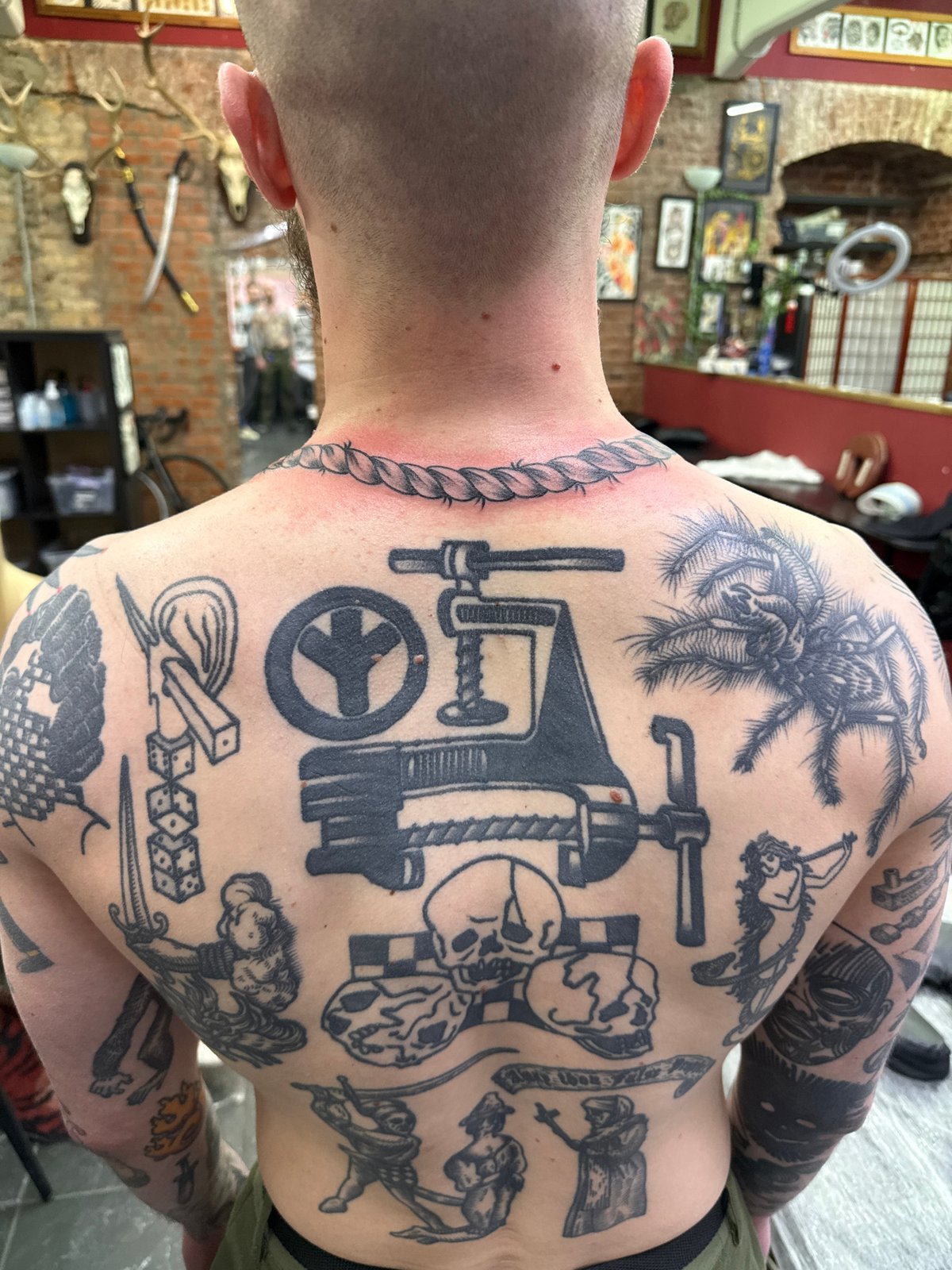 Heavily tattooed man photographed at Moscow tattoo parlor