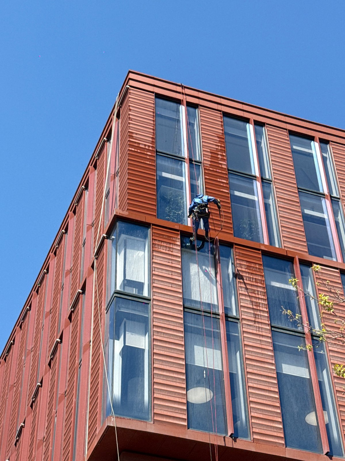 Window washer cleans high-rise building facade in Khimki, Russia