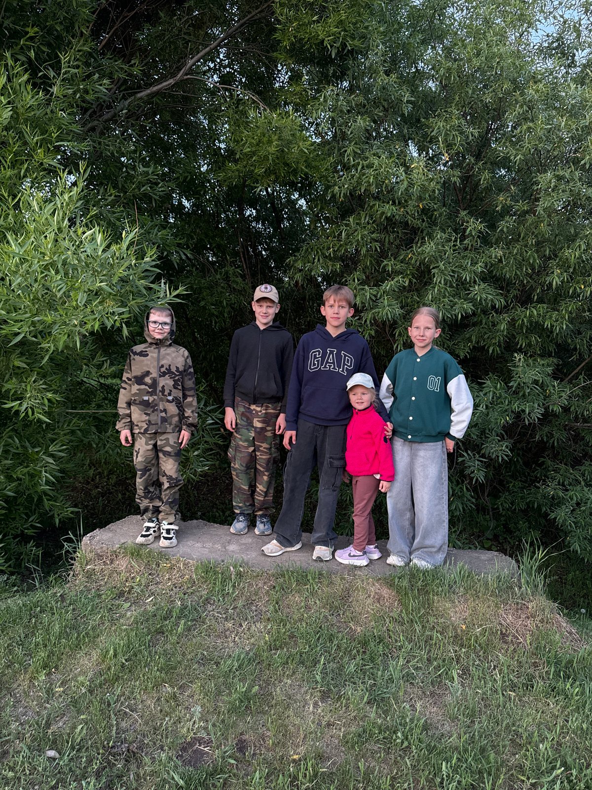 Families gather for evening activities in Горный, Russia