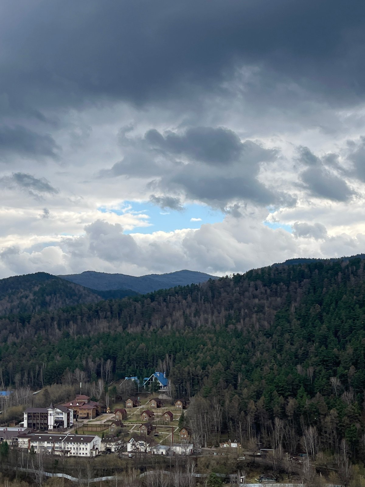 Tourist documents bear statue with coins at Krasnoyarsk overlook