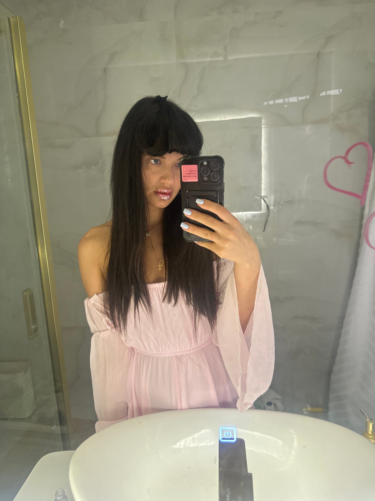 Woman takes mirror selfie in light pink outfit, Moscow