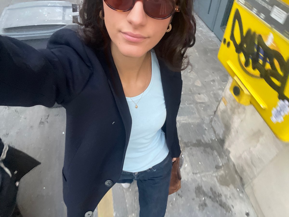 Woman takes selfies on Paris street evening