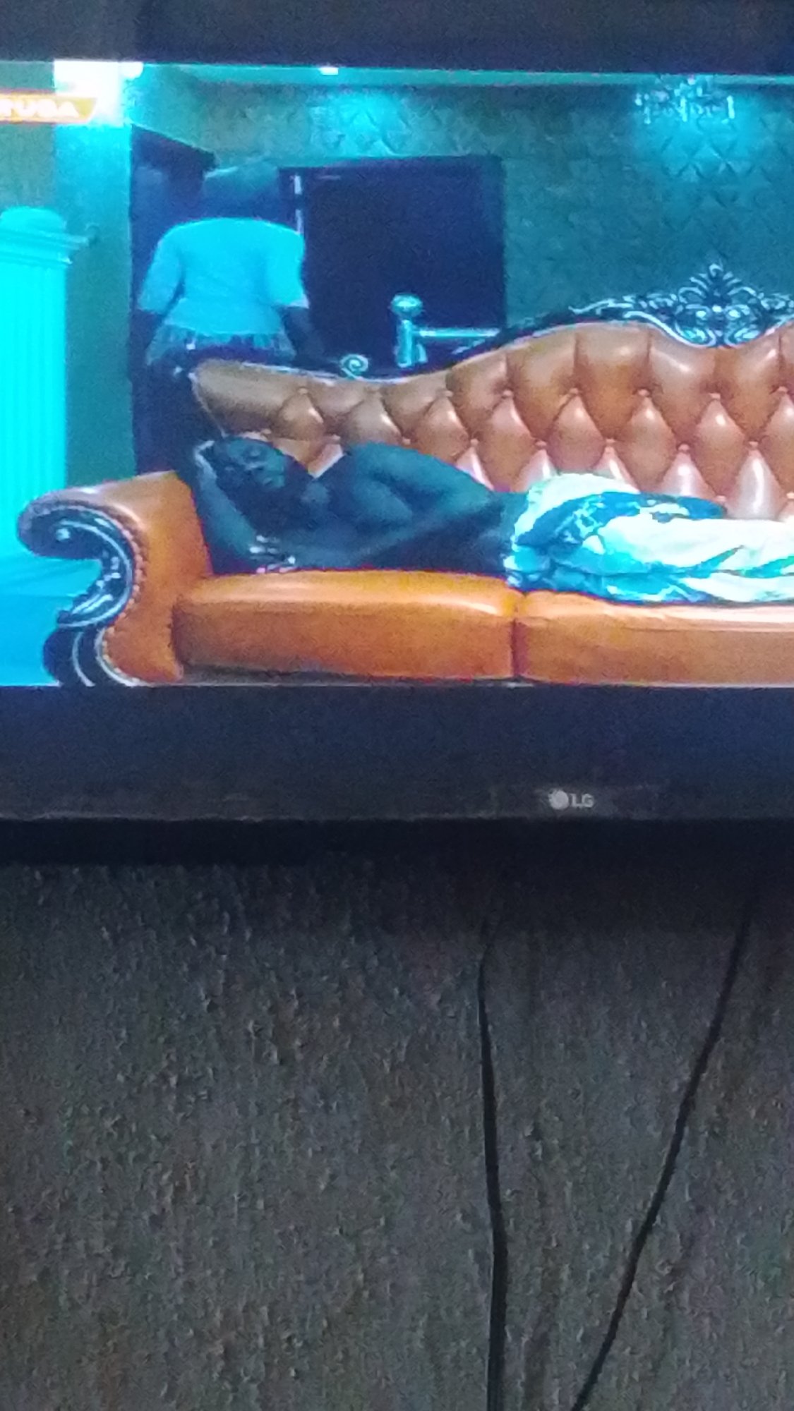Nigerian viewer watches mixed TV programming in Lokoja morning session