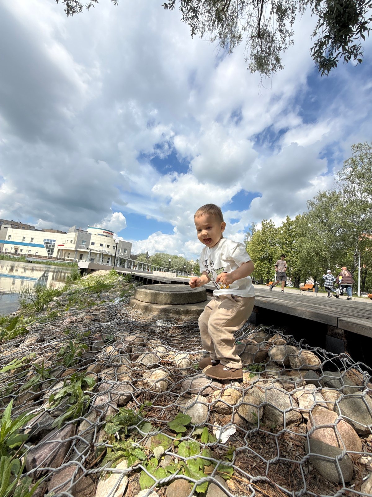 Woman and toddler enjoy morning waterfront visit in Rusanovo