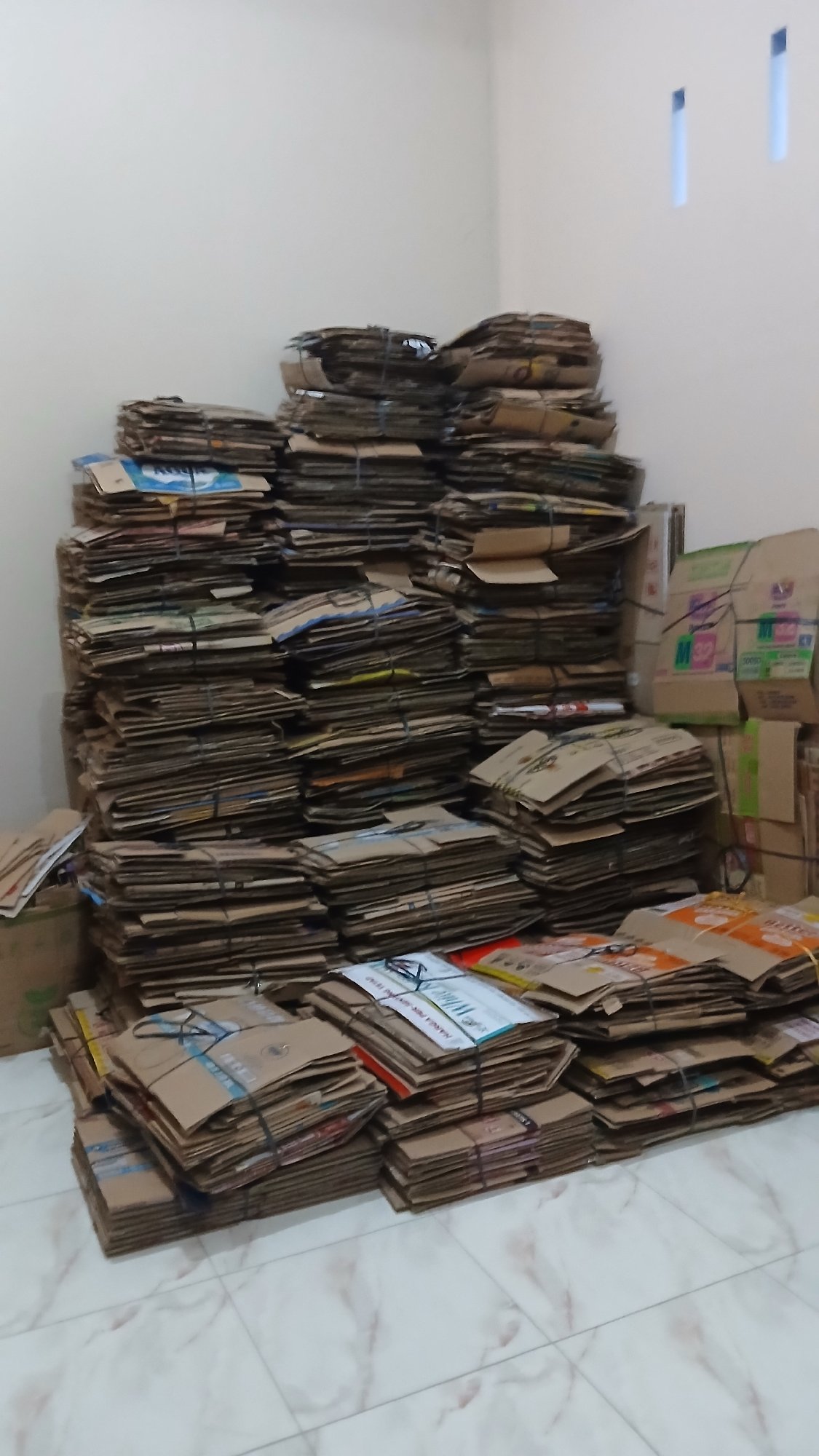 Cardboard boxes bundled for recycling in Lhokseumawe facility