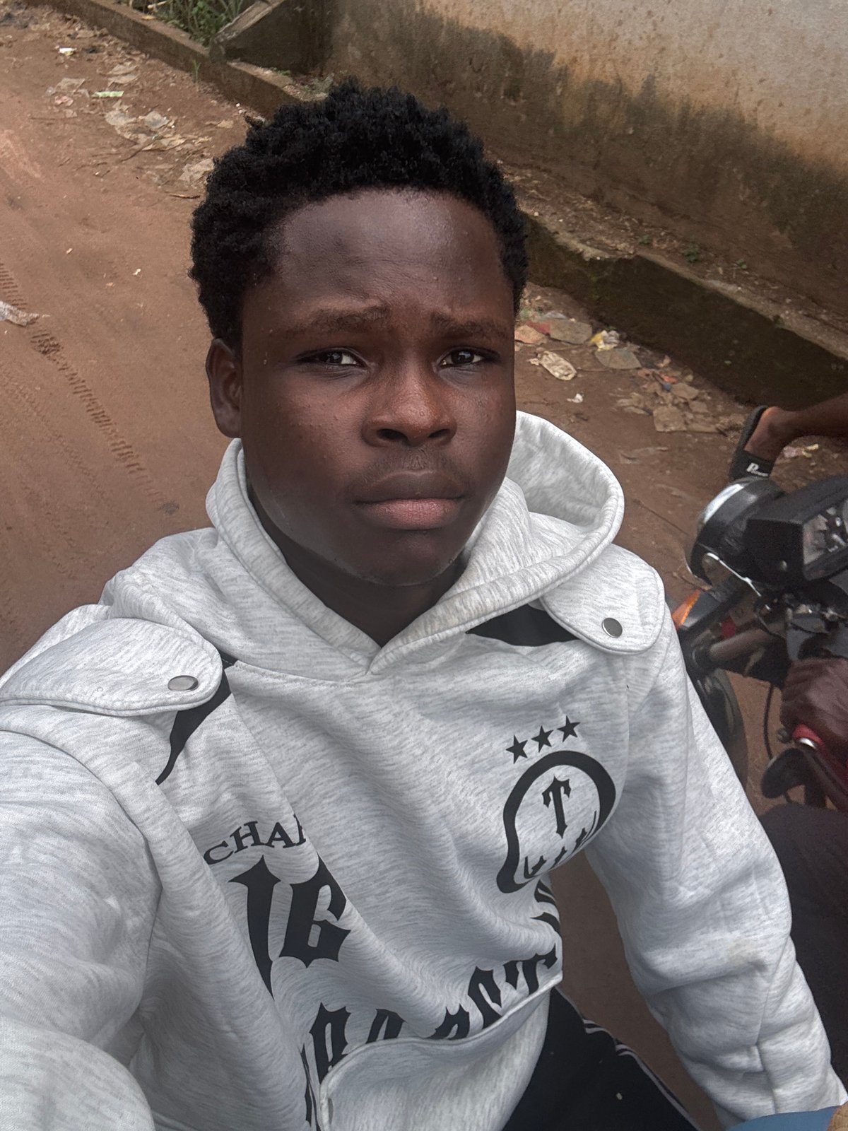 On a motorcycle in Ihiagwa, Nigeria, facing the camera