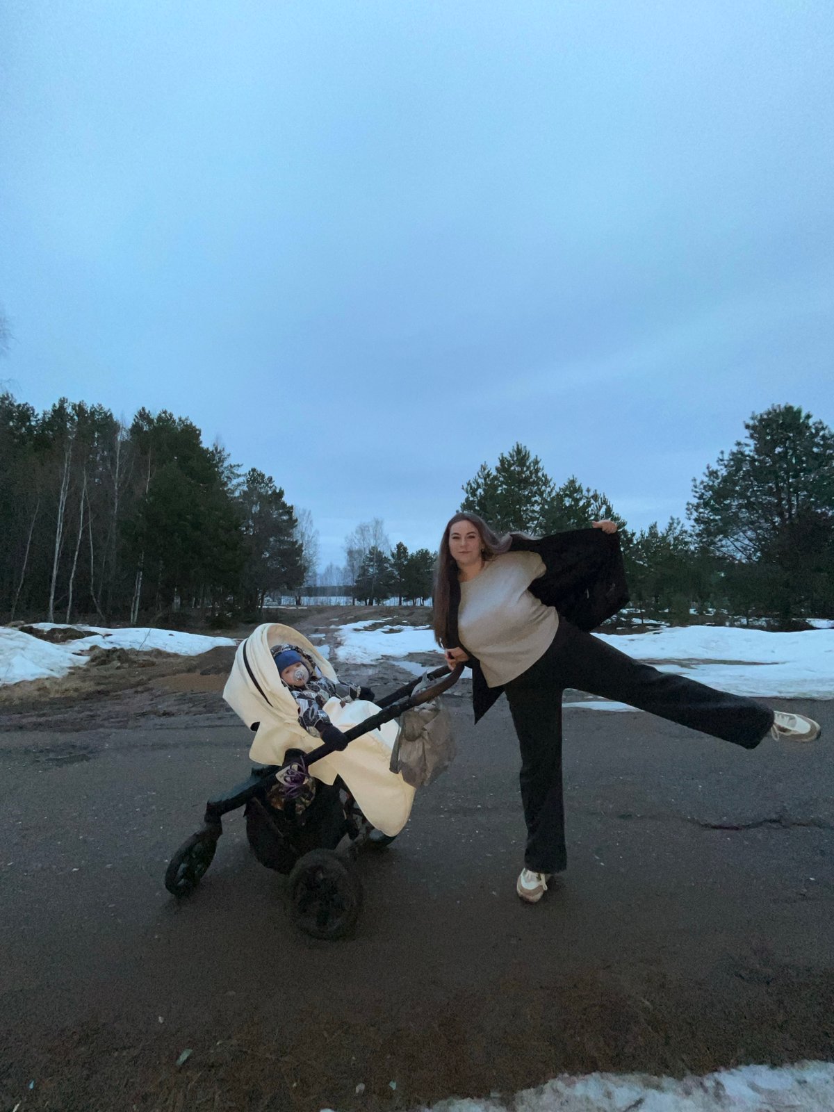Mother and child captured on snowy roadside in Chaikovsky