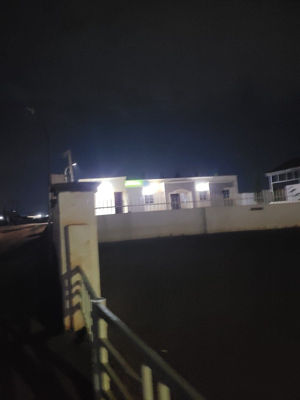 Nighttime street scenes from a wet Abuja road